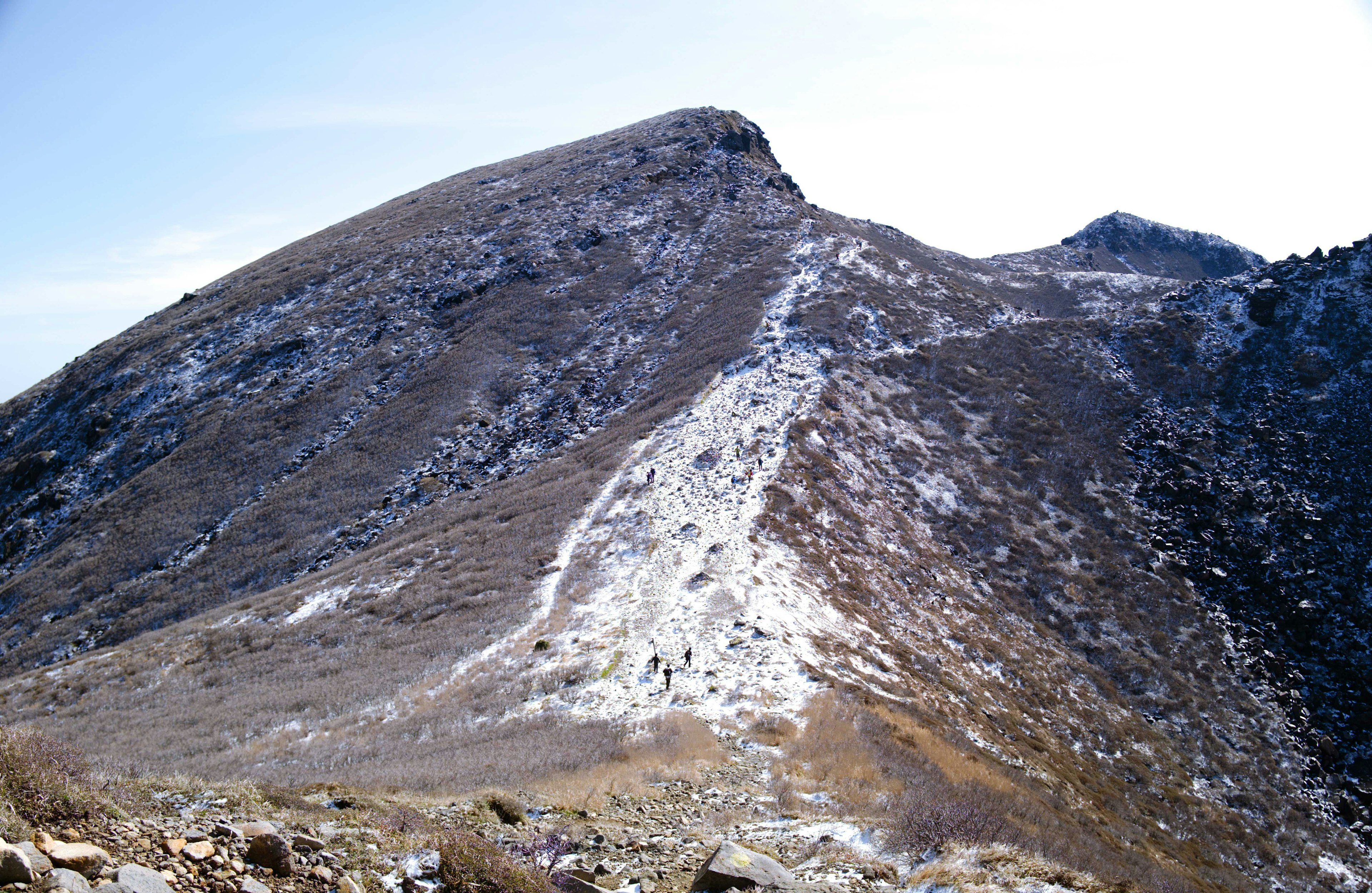 Snow-covered mountain slope with a clear blue sky