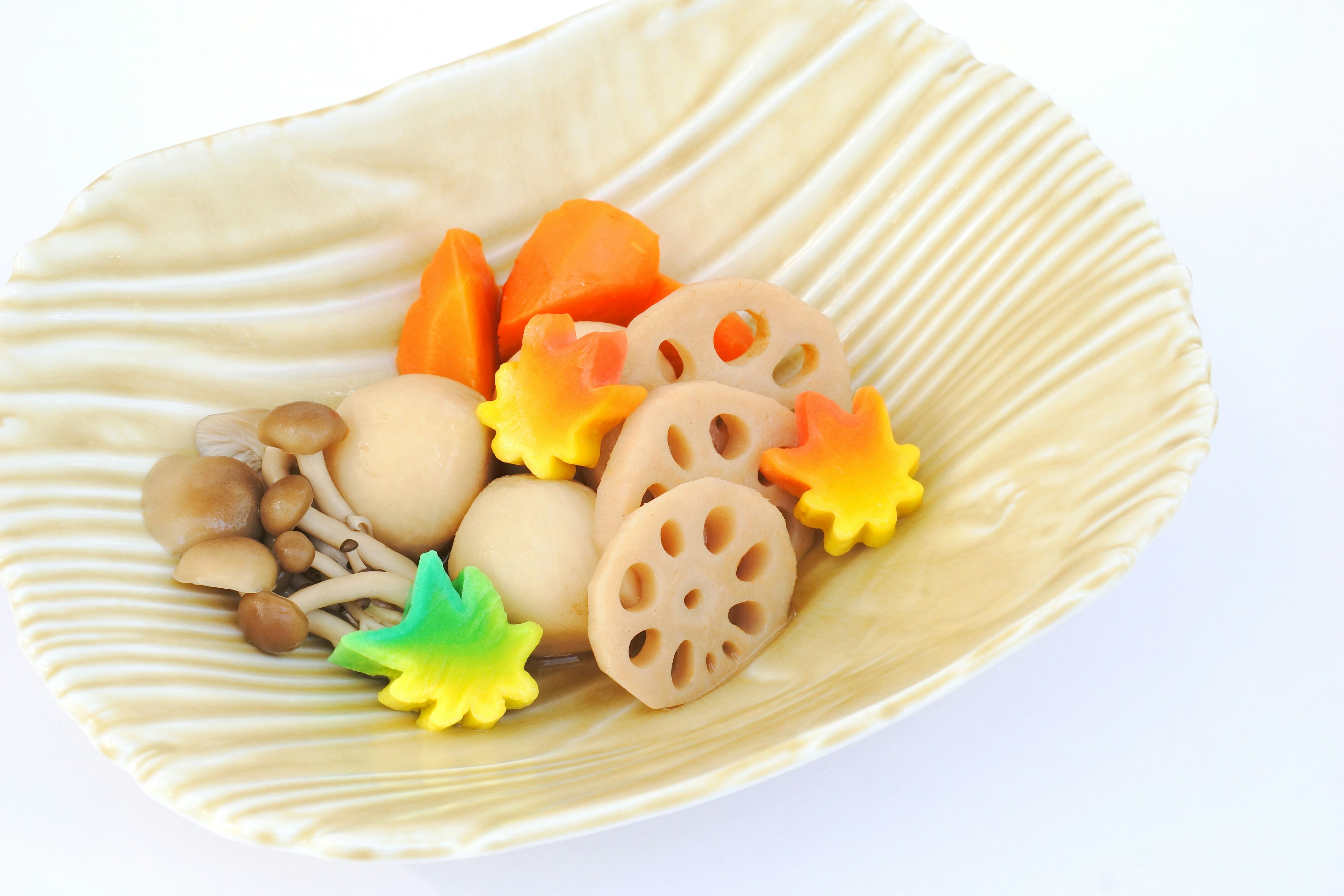 Colorful vegetables and decorative ingredients arranged in a white bowl