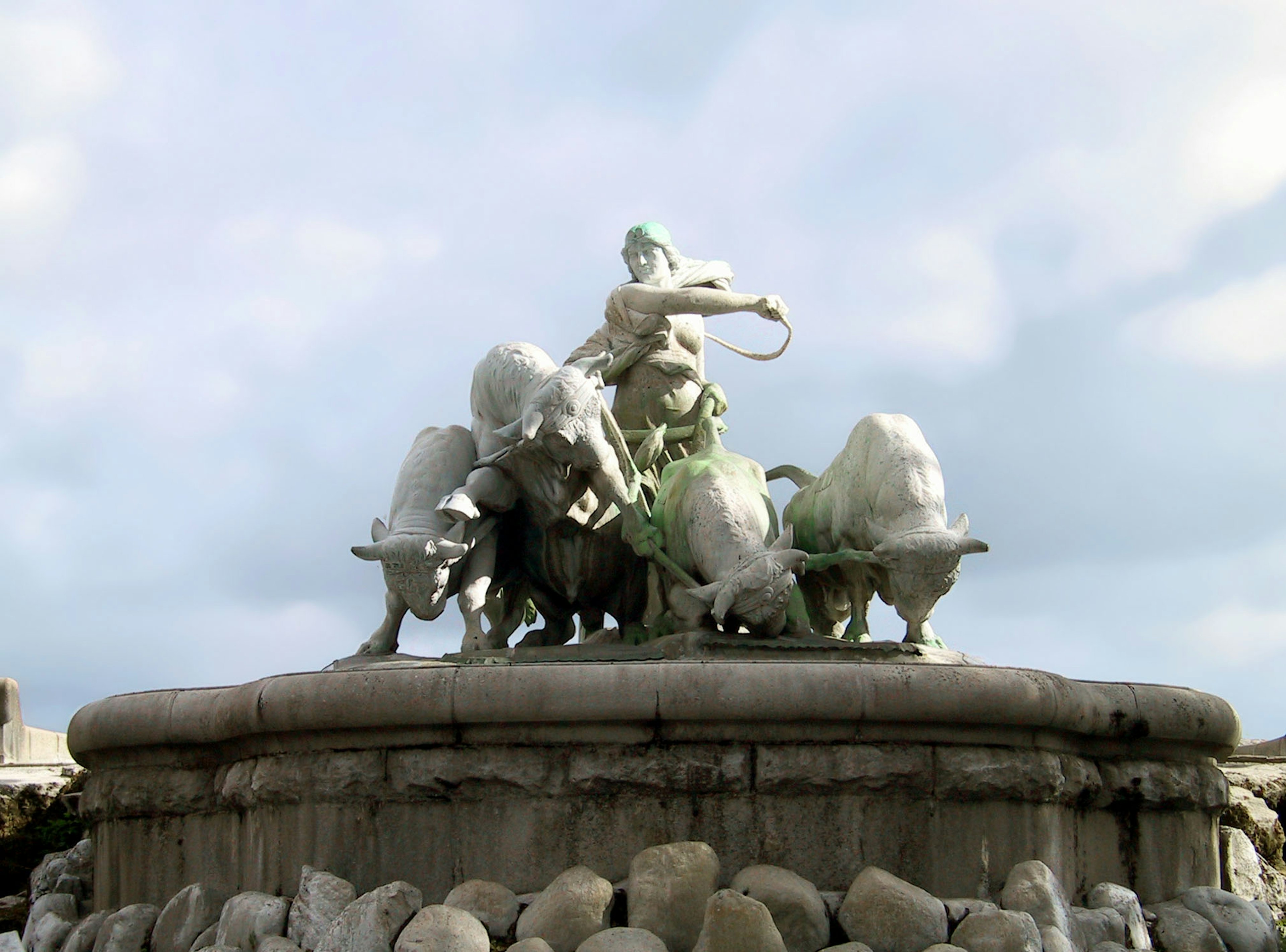 Figure mythique tirant des taureaux au centre d'une fontaine sculptée