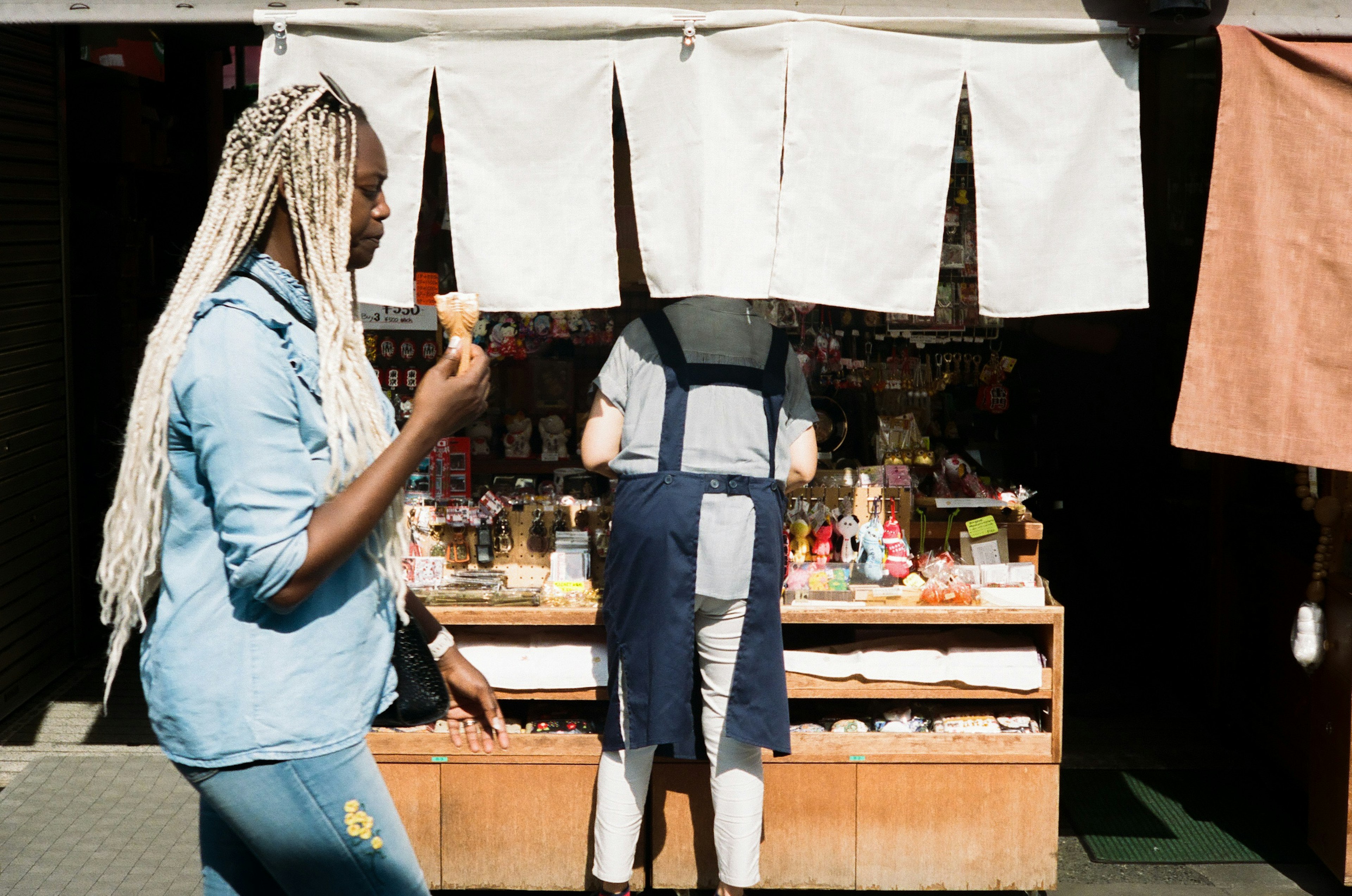 A woman walking in a market holding food