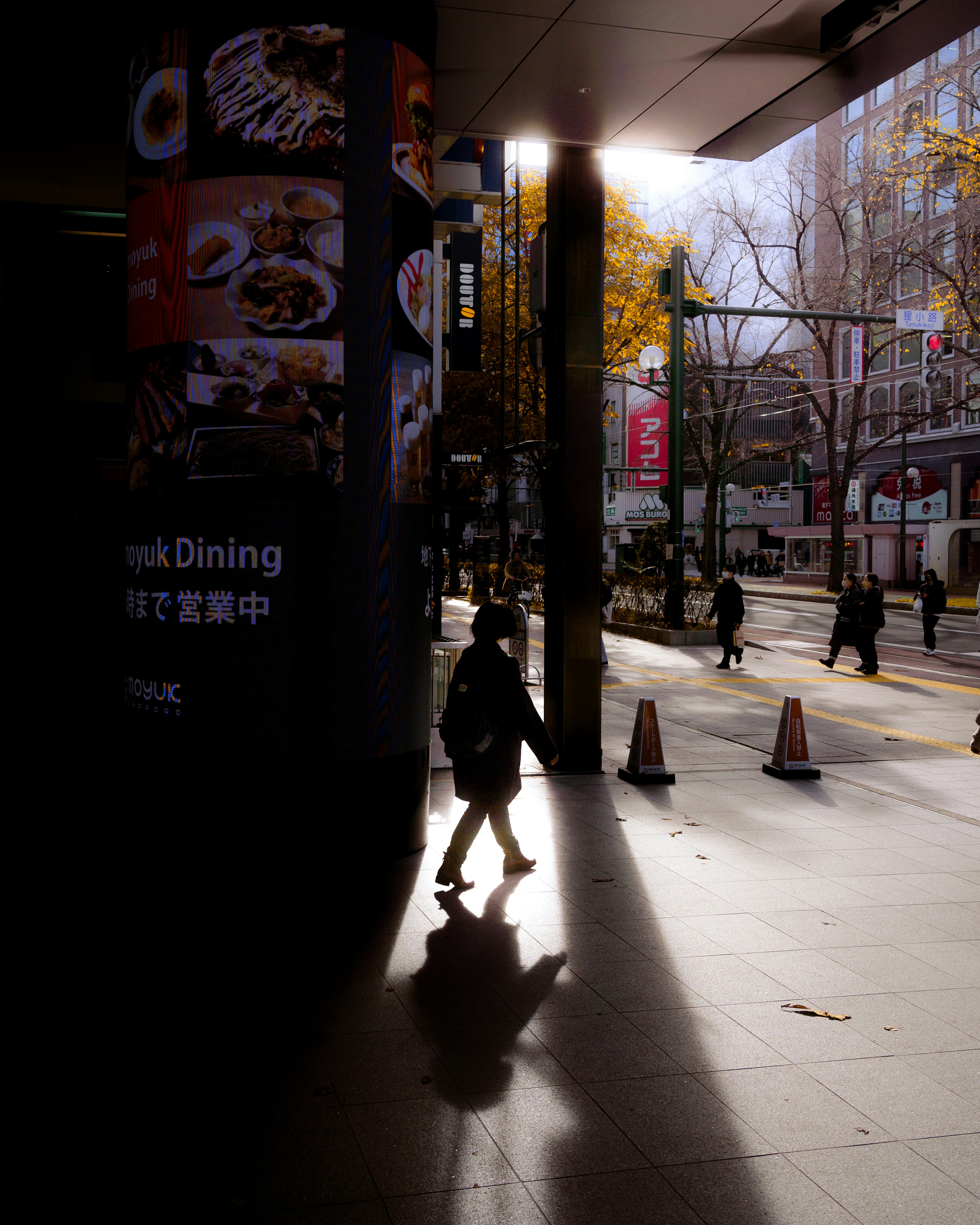 Street scene highlighting contrast of shadows and light