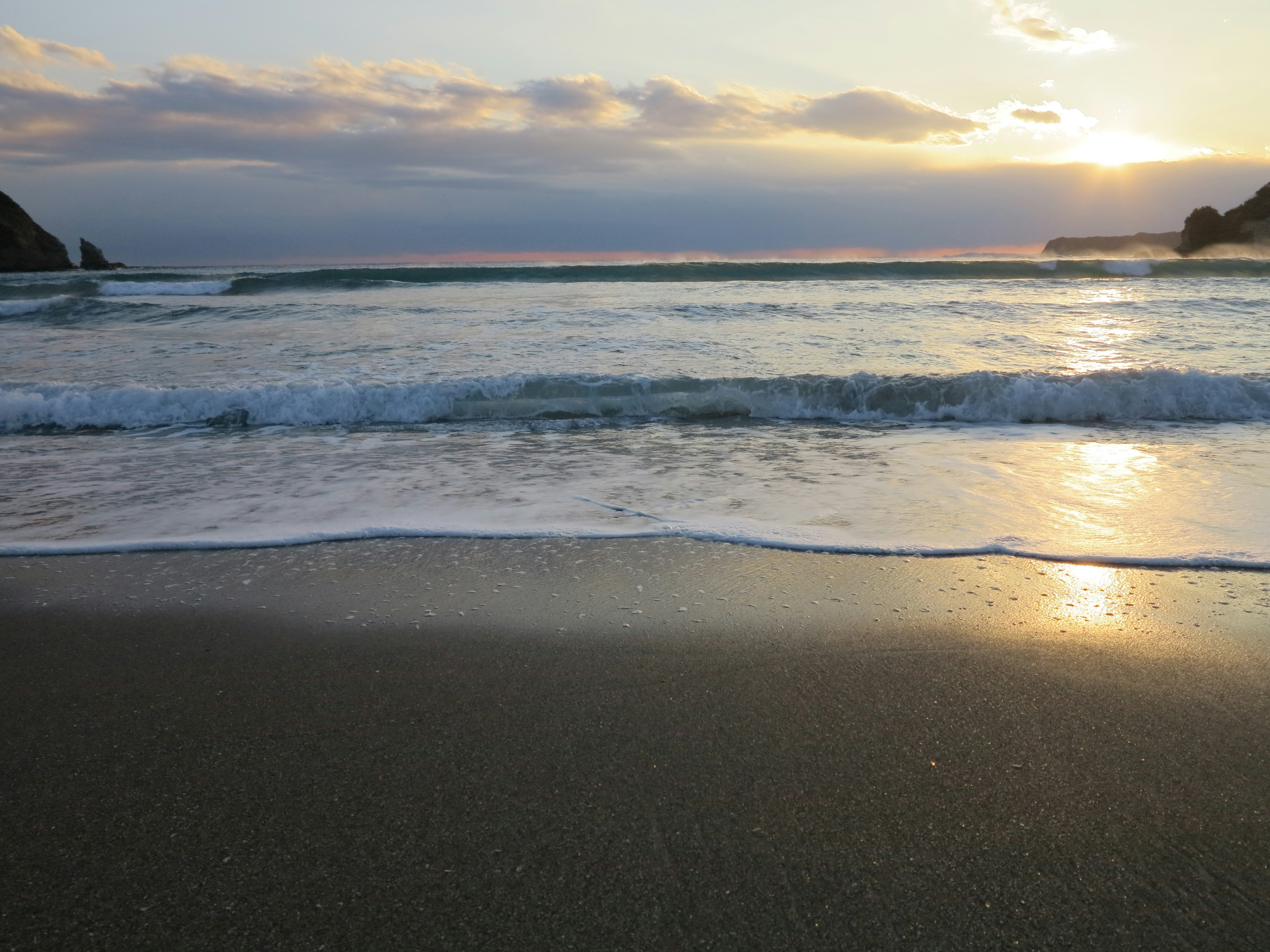 Beautiful shoreline with waves sunset over the ocean