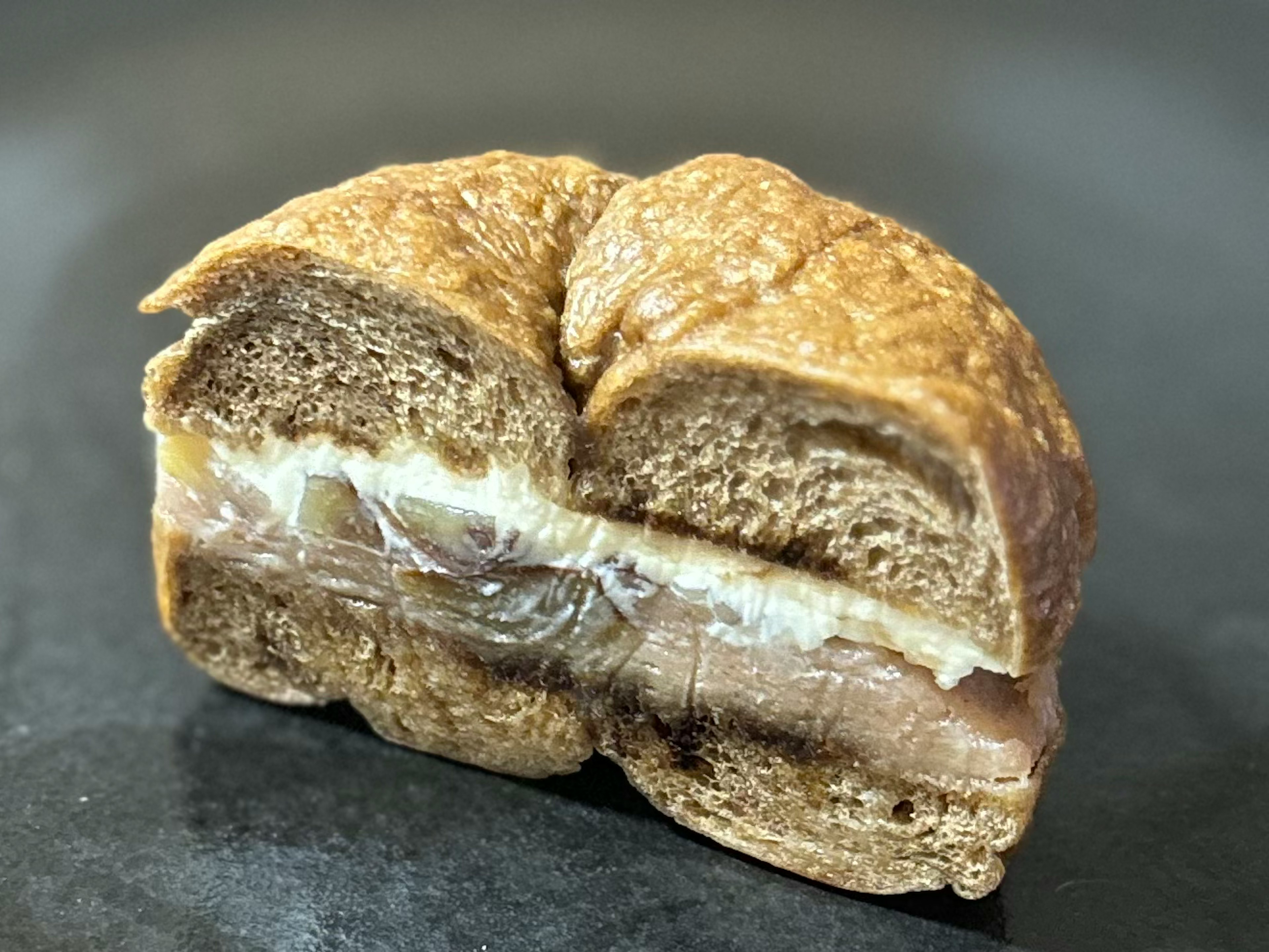 Image showing the cross-section of a cut bread with a toasted exterior and creamy filling