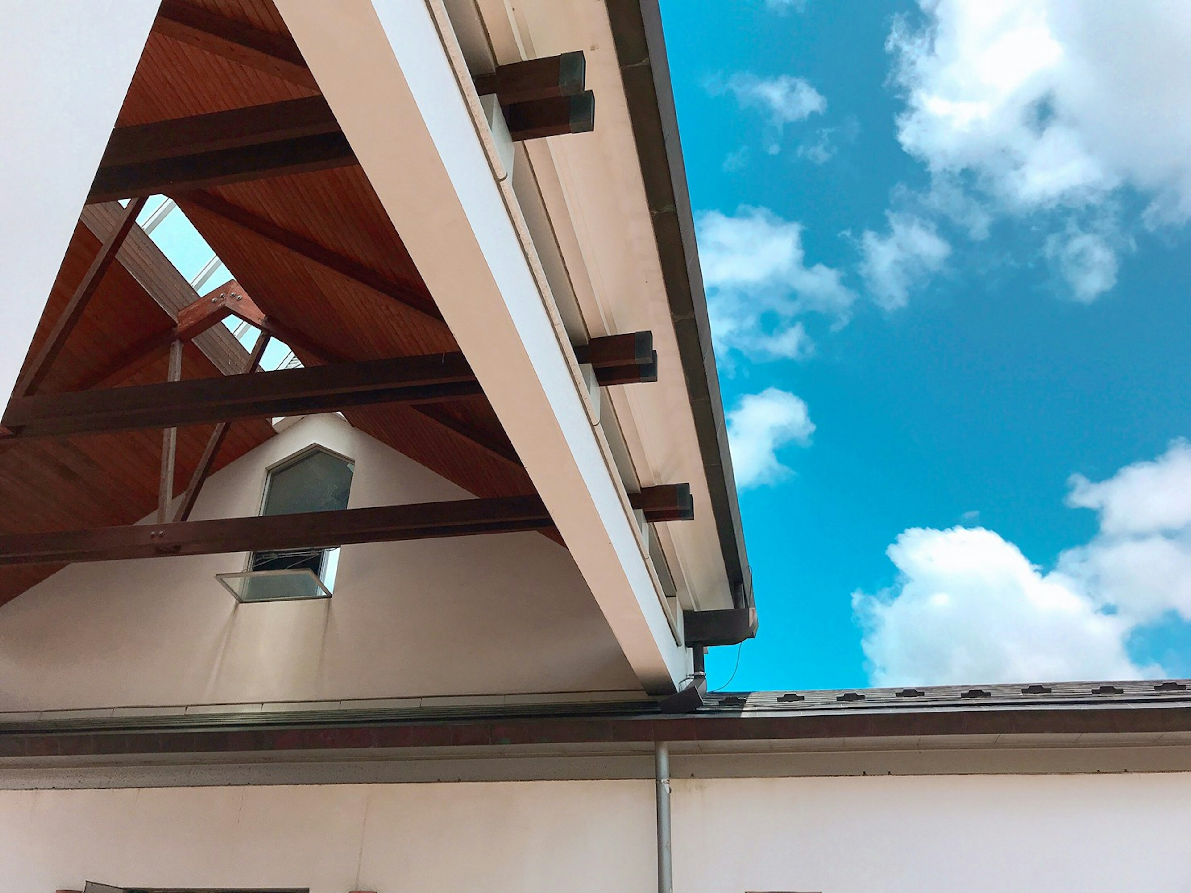 Building structure with roof details and blue sky