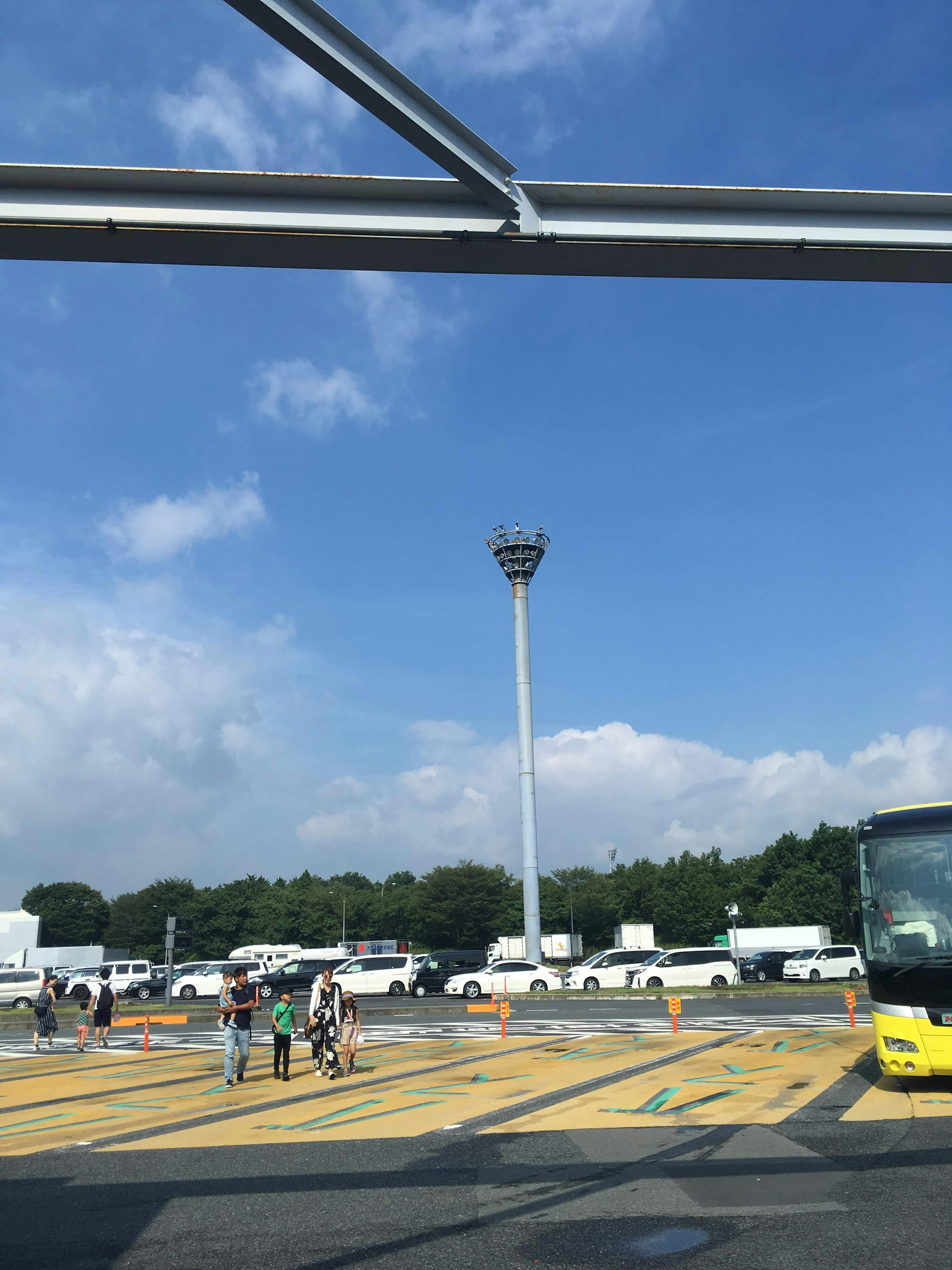 A view of a parking lot and bus under a blue sky