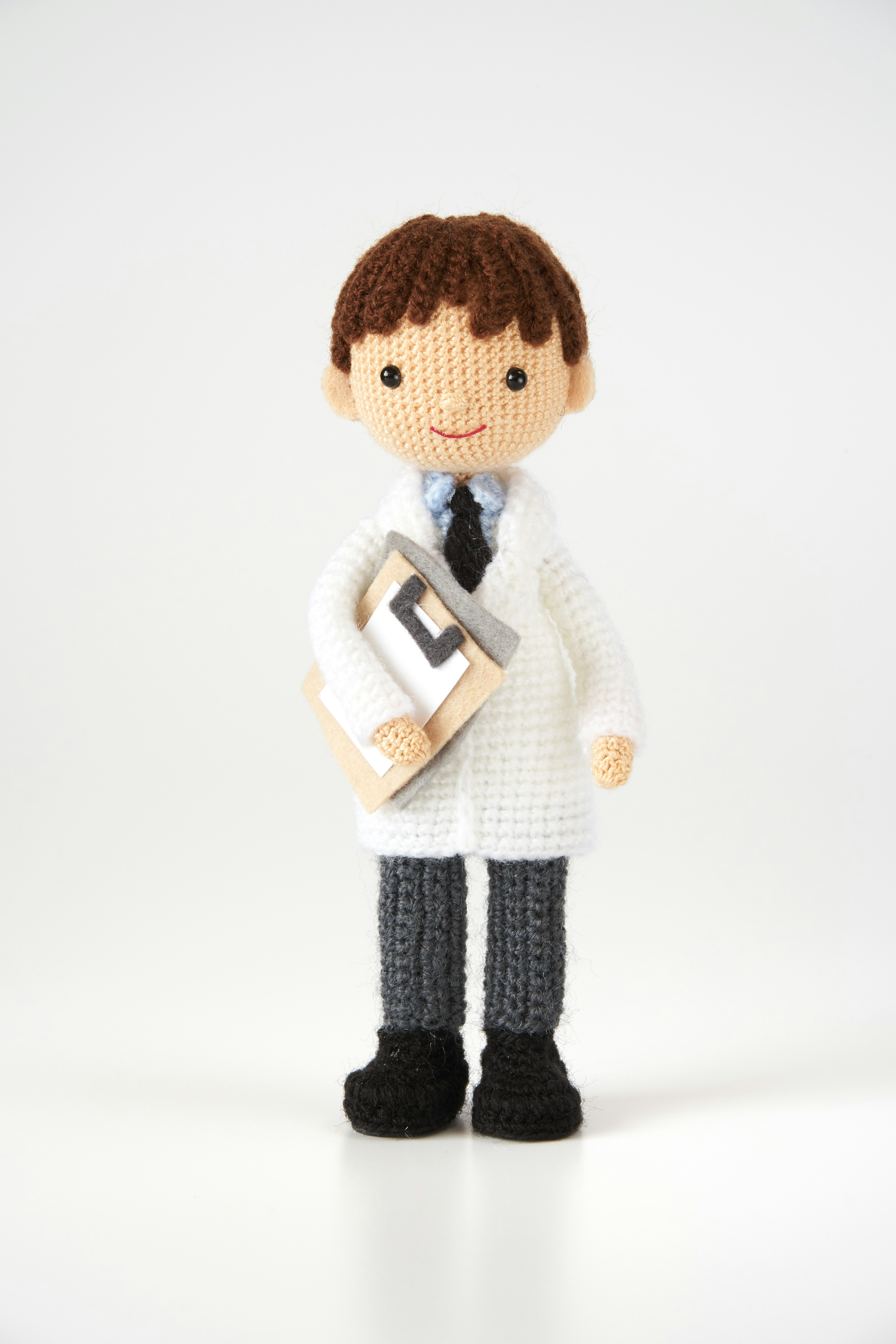 A plush doll of a doctor wearing a white coat holding a clipboard