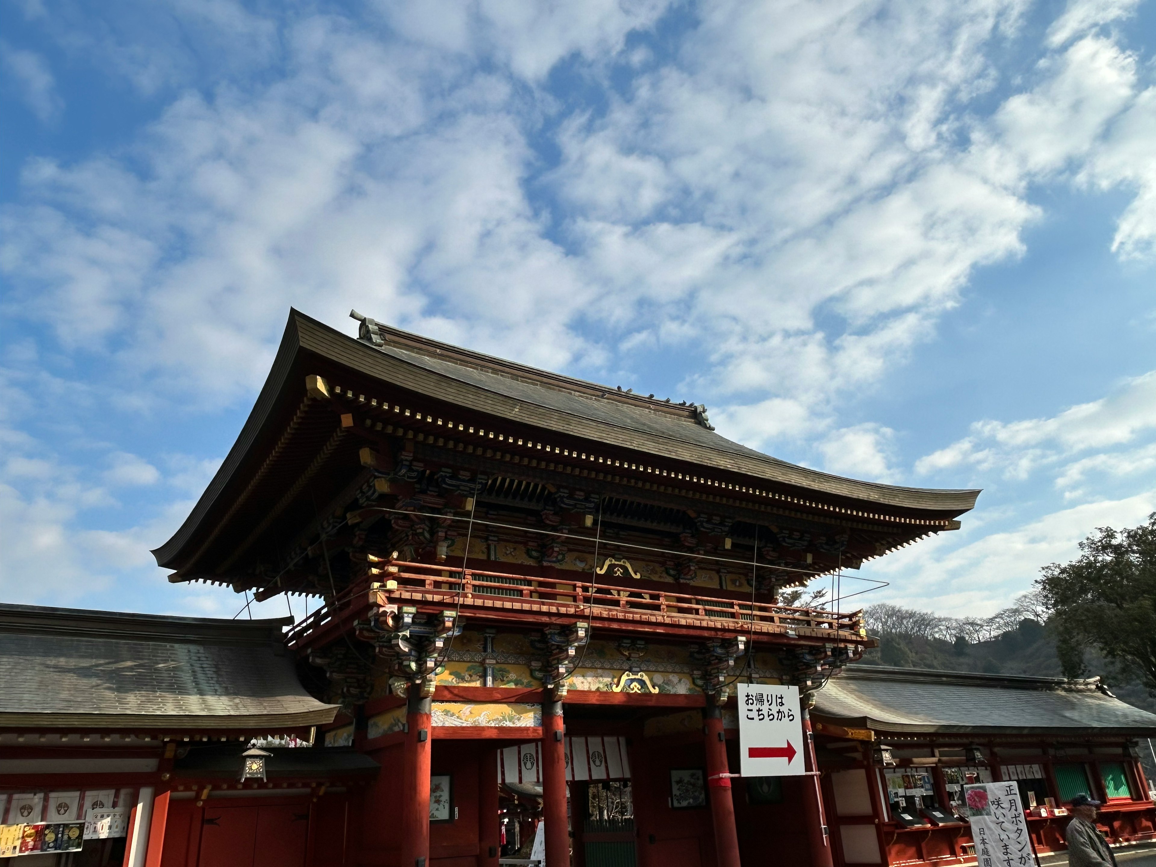 Traditional Japanese shrine entrance under a beautiful blue sky