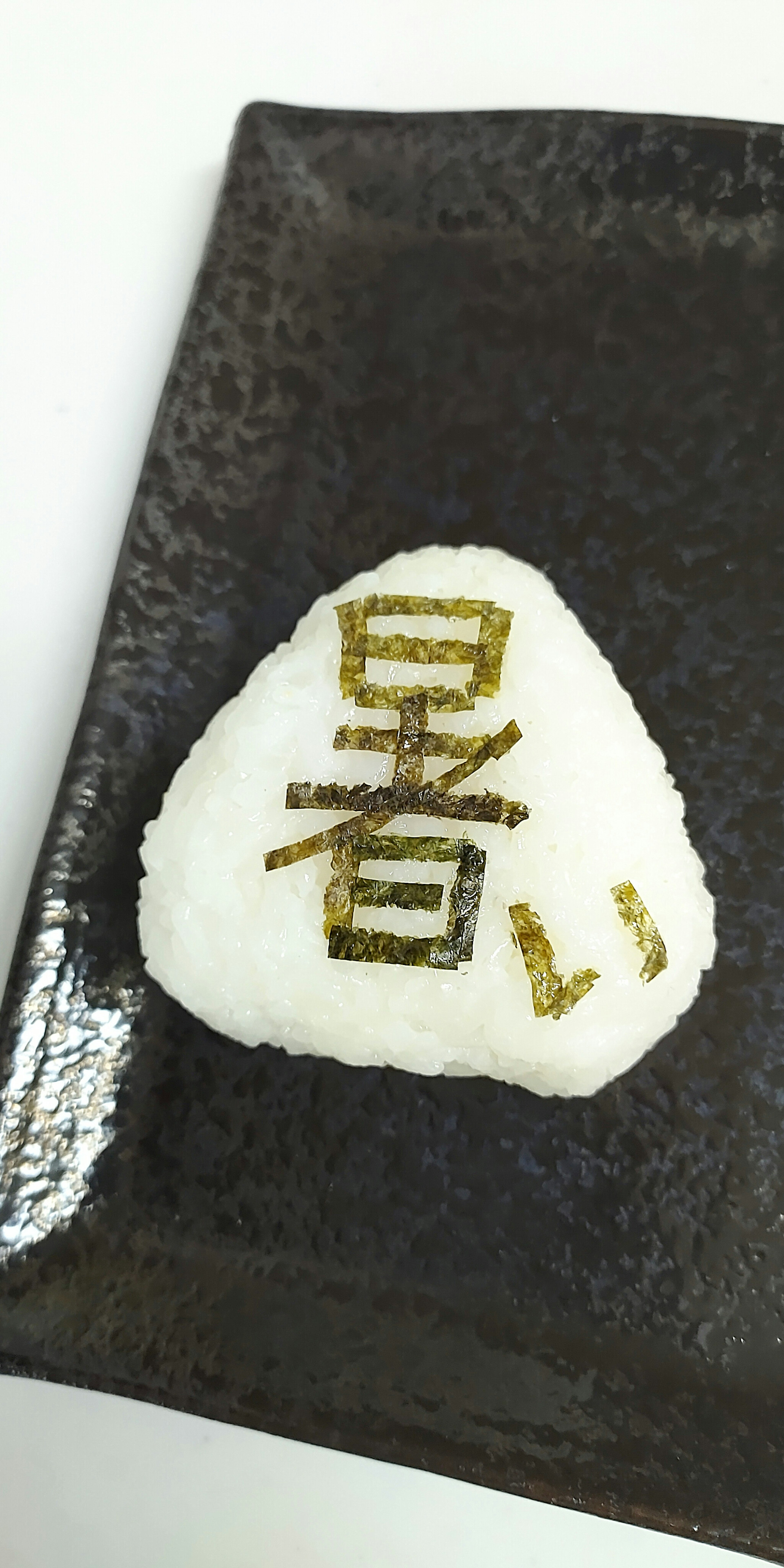 Boule de riz en forme de triangle avec des caractères kanji