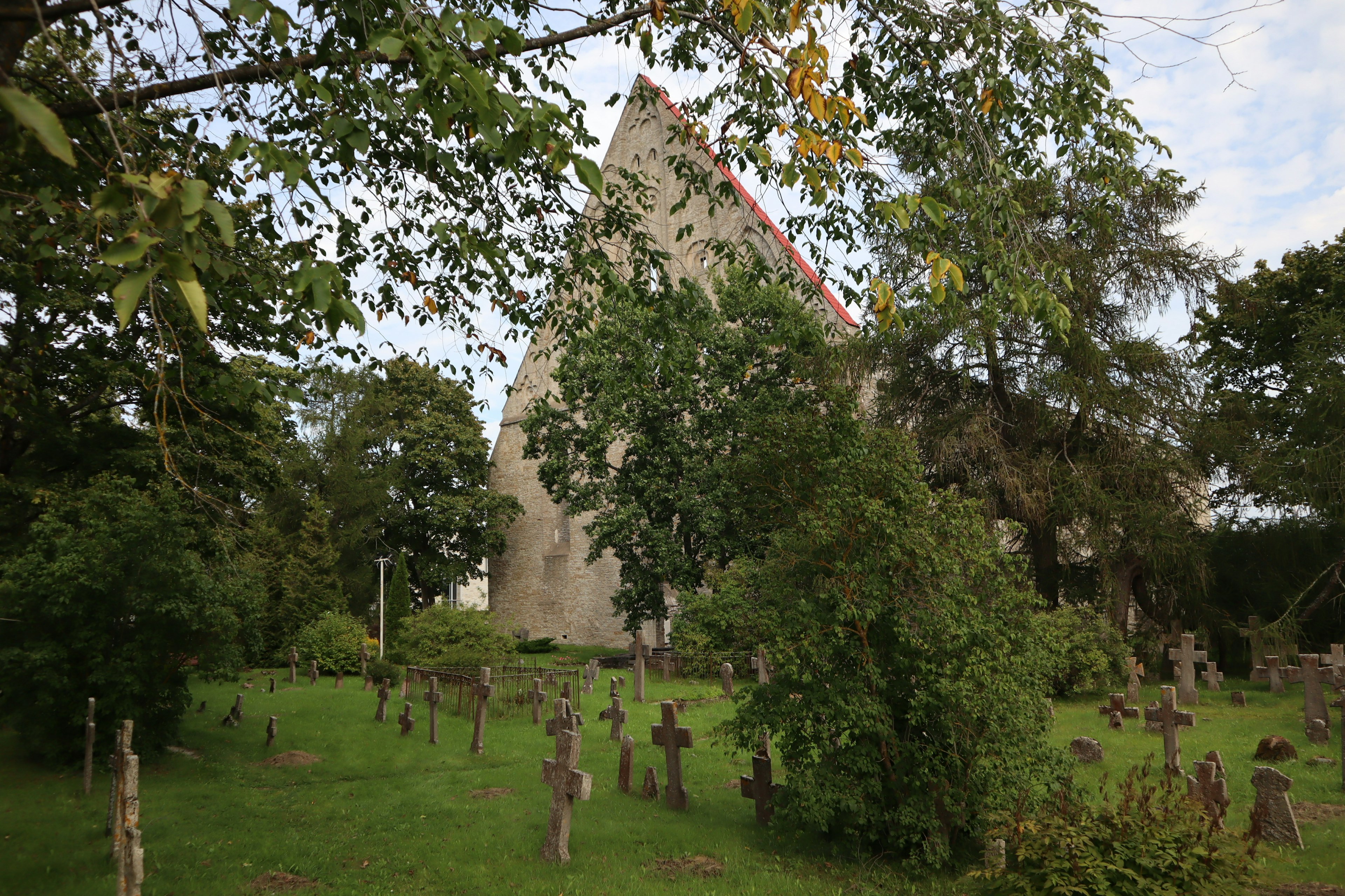 Triangular building surrounded by grass and trees