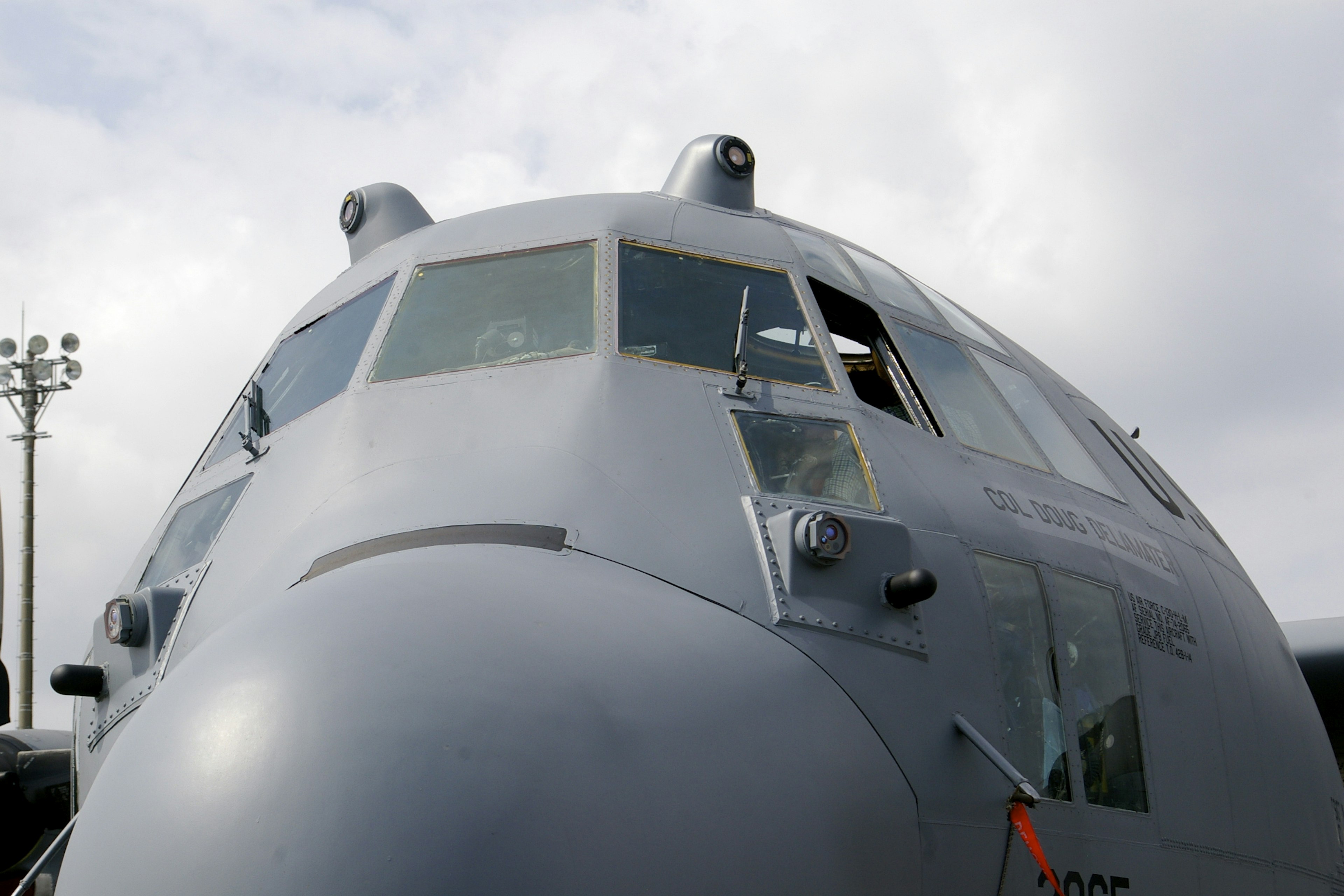 Close-up of an aircraft's front featuring a gray body and large windows