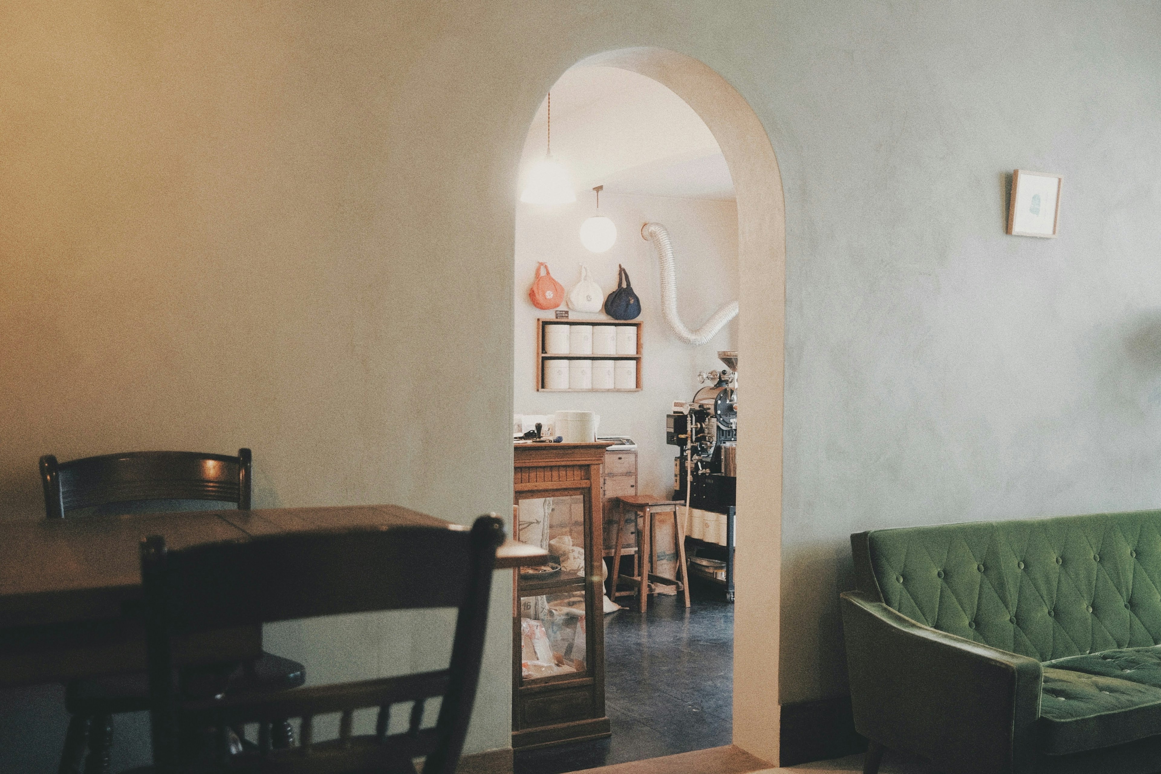 Cozy indoor scene with an arched entrance featuring warm lighting and harmonious furniture design