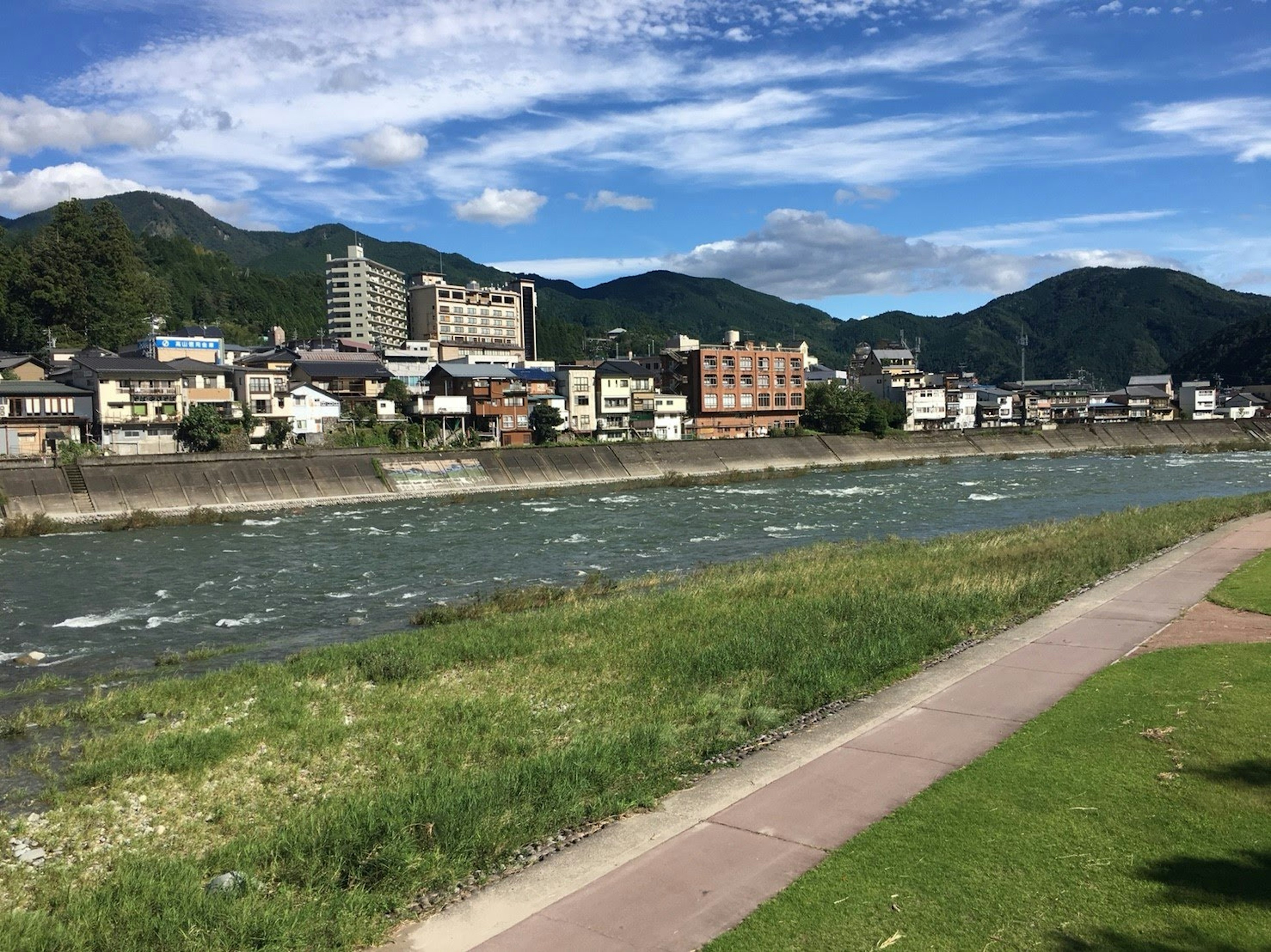 Vista panoramica di un fiume circondato da edifici e montagne