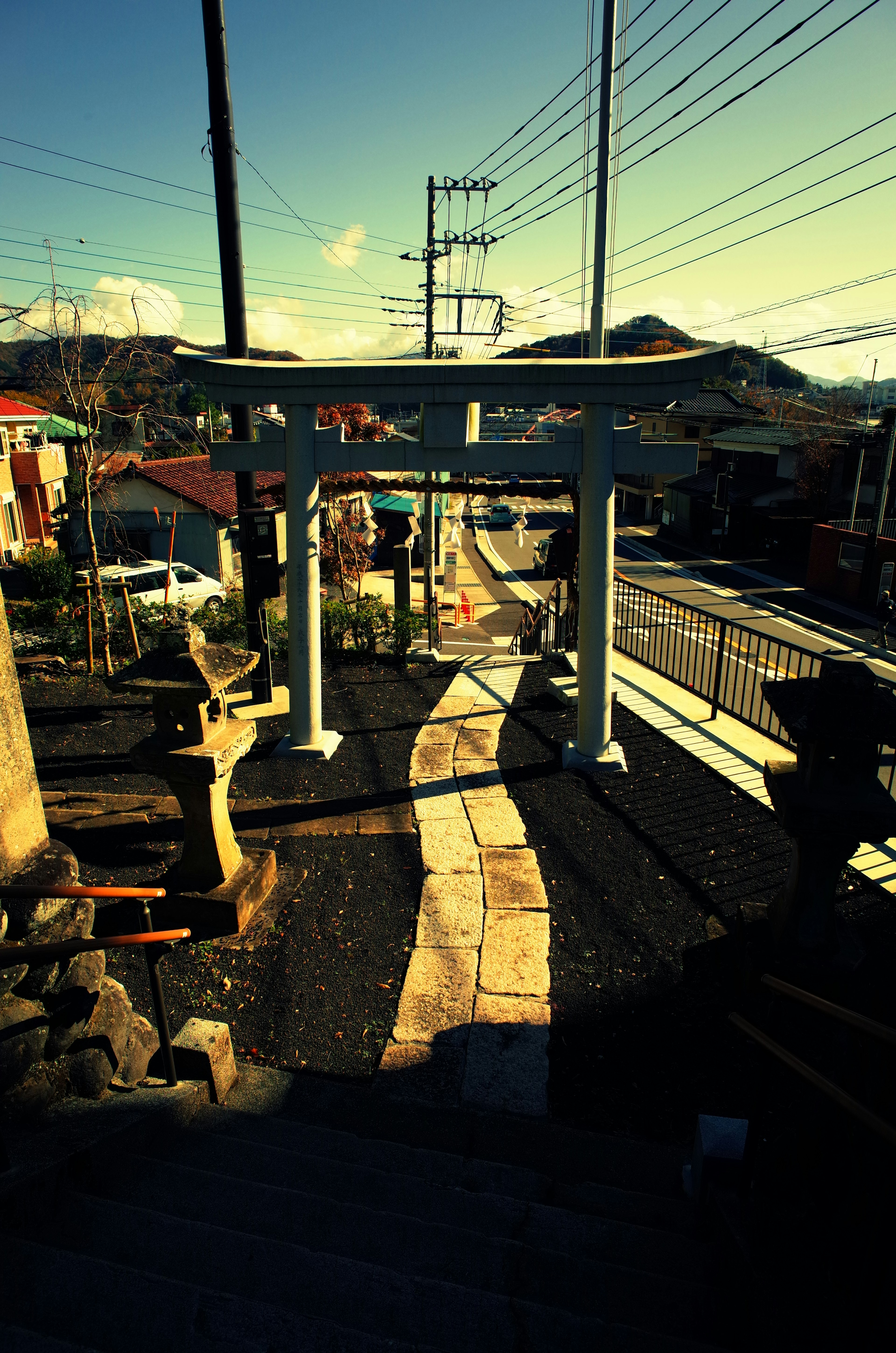 Gerbang torii membingkai jalan dengan pemandangan sekitar