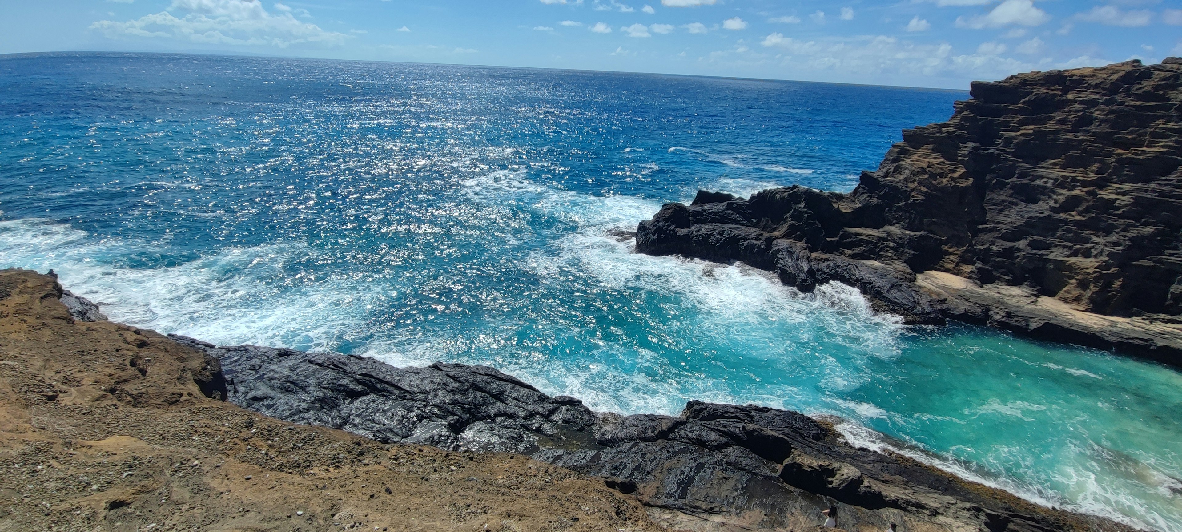 Scenic view of blue ocean and rocky shoreline