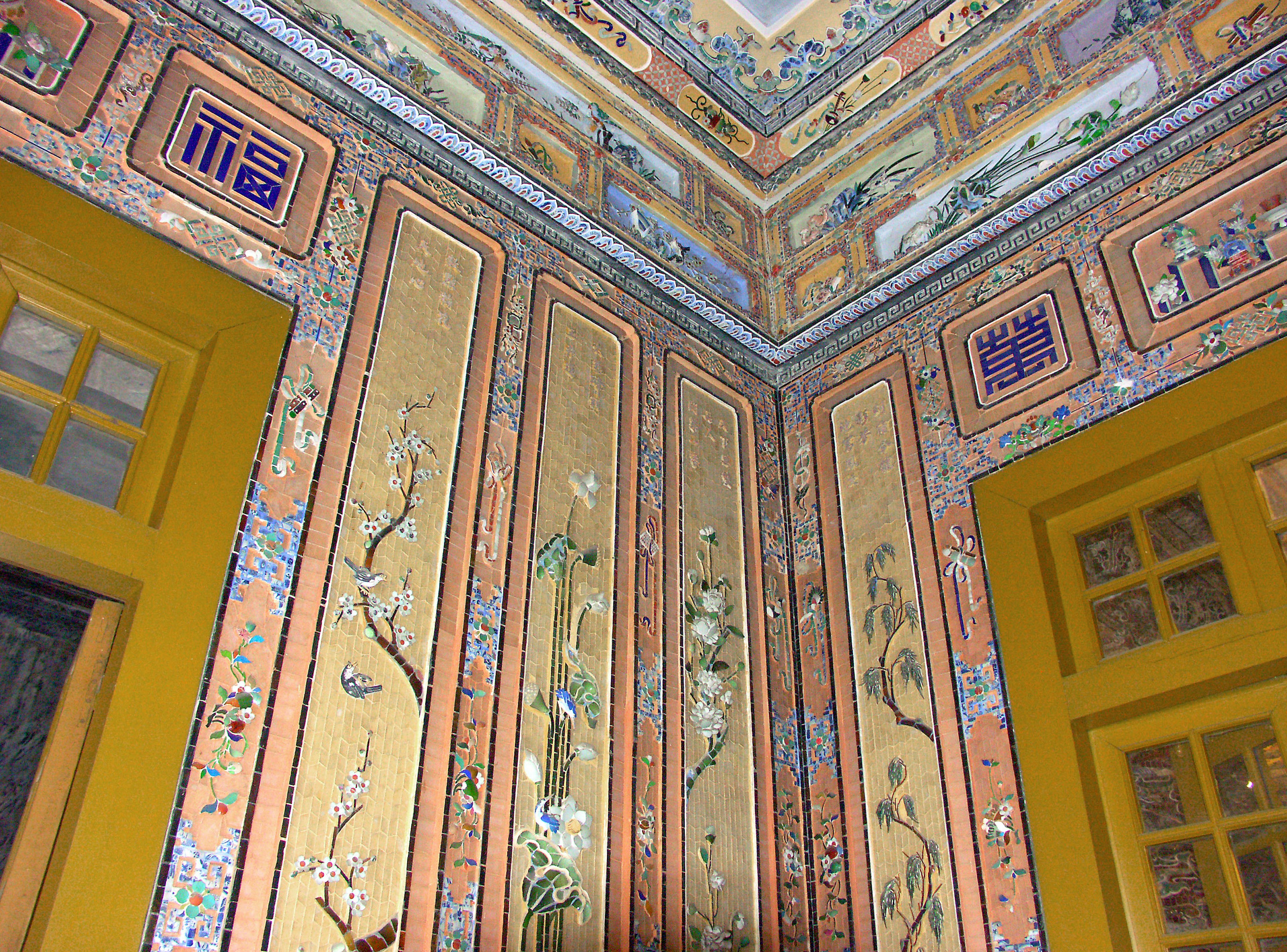 Decorative corner of a wall and ceiling featuring colorful floral patterns