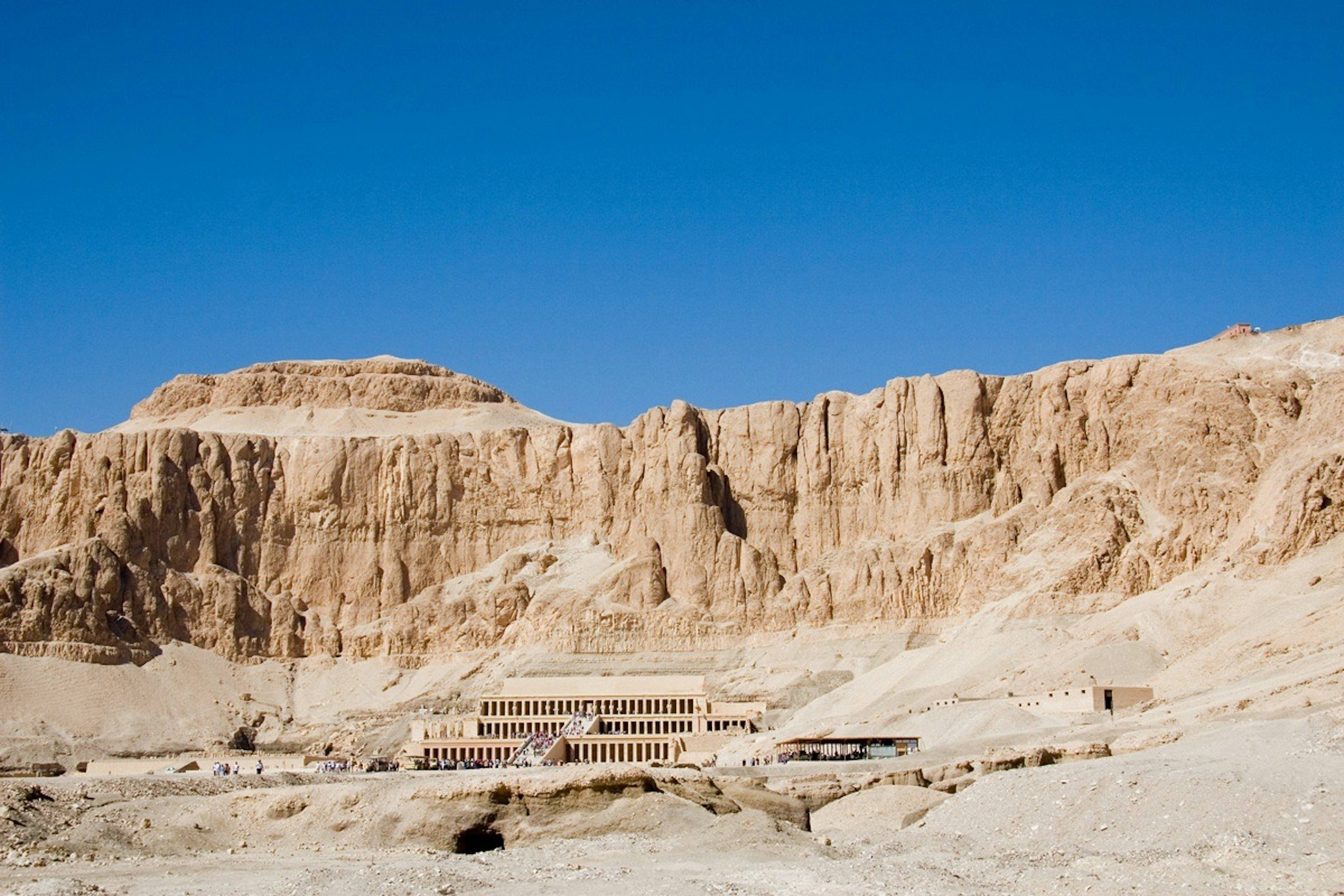 Desert landscape with ancient Egyptian ruins under a clear blue sky