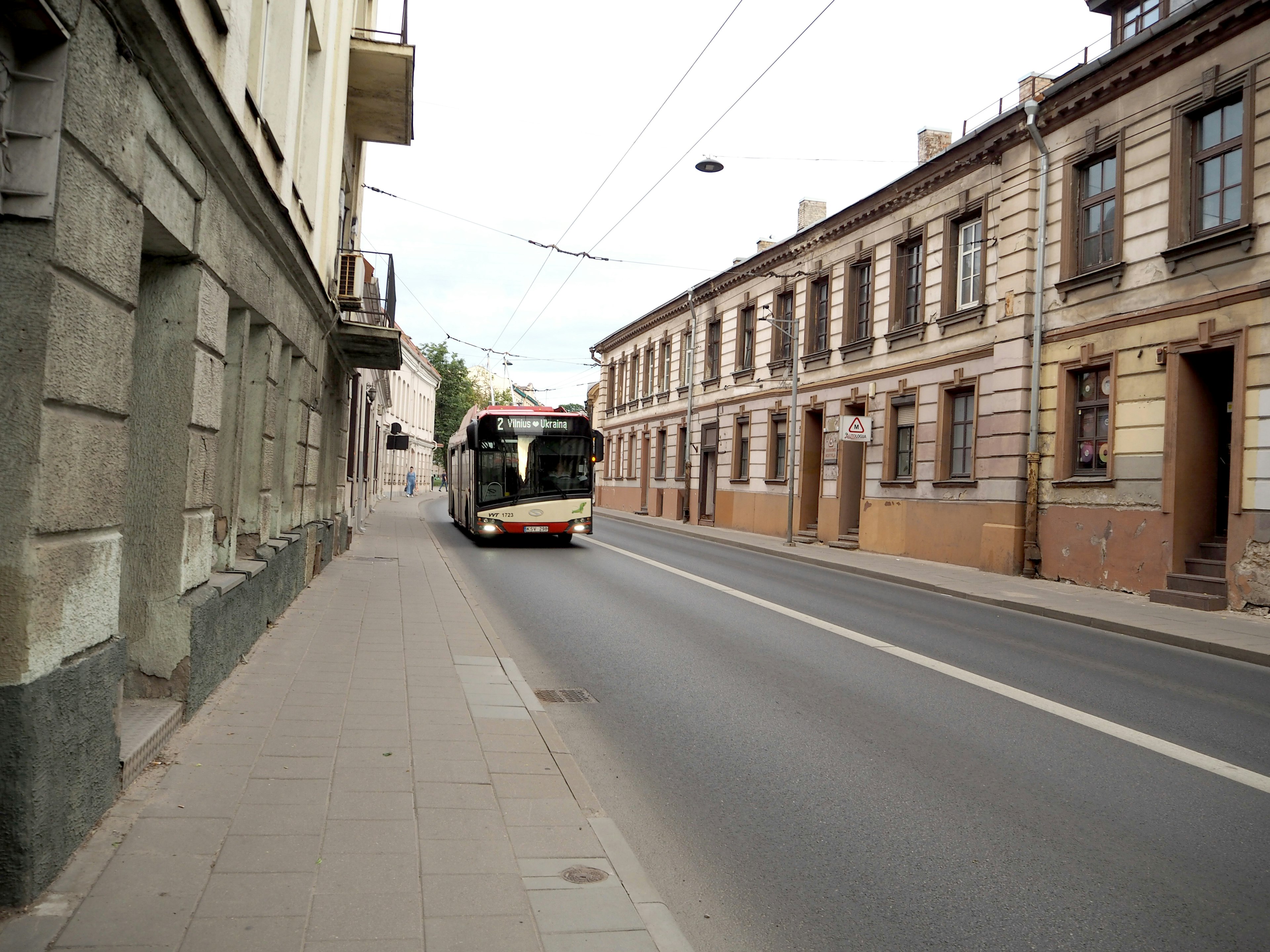 A street scene featuring a bus and historic buildings