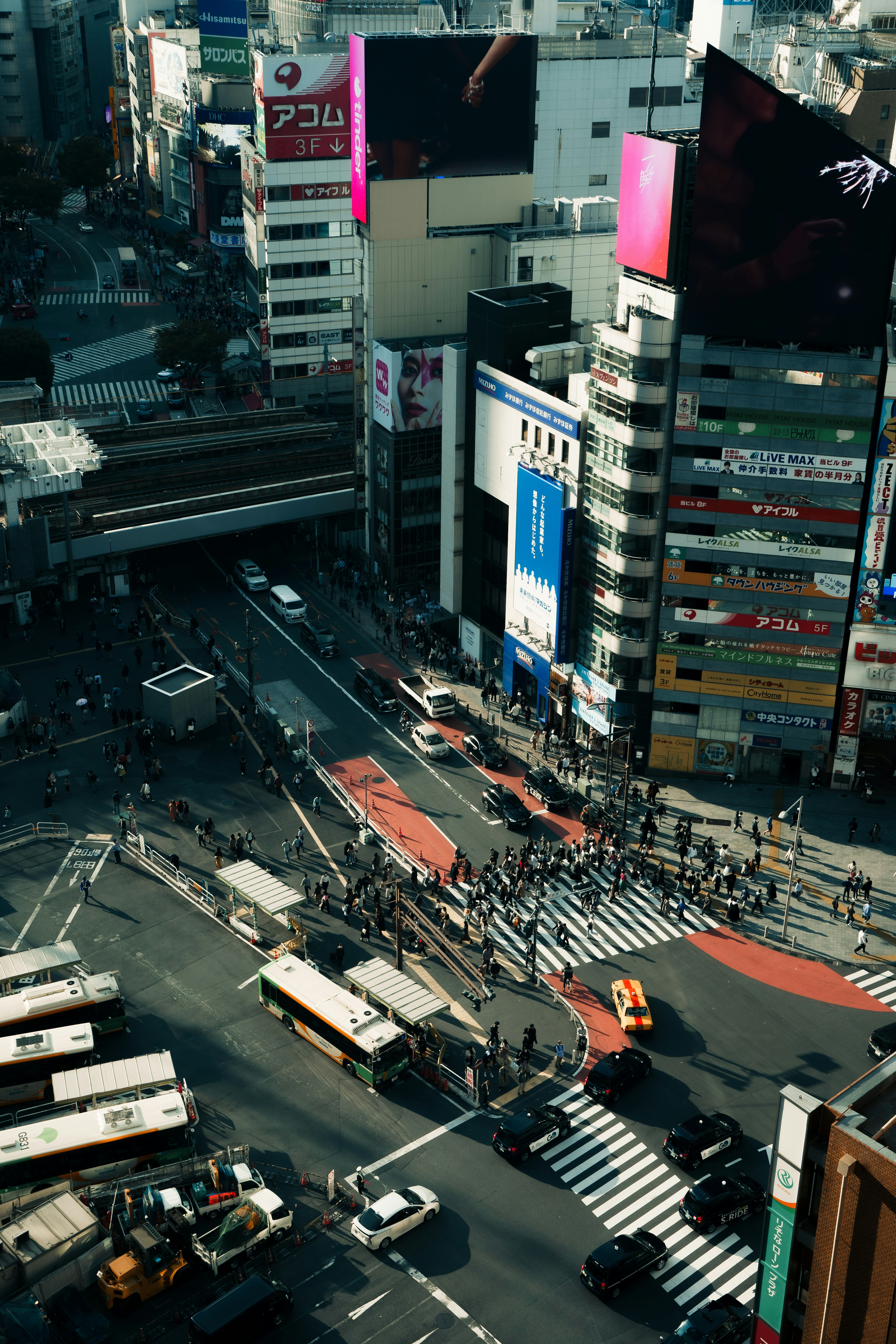 Urban intersection with bustling crowds and traffic