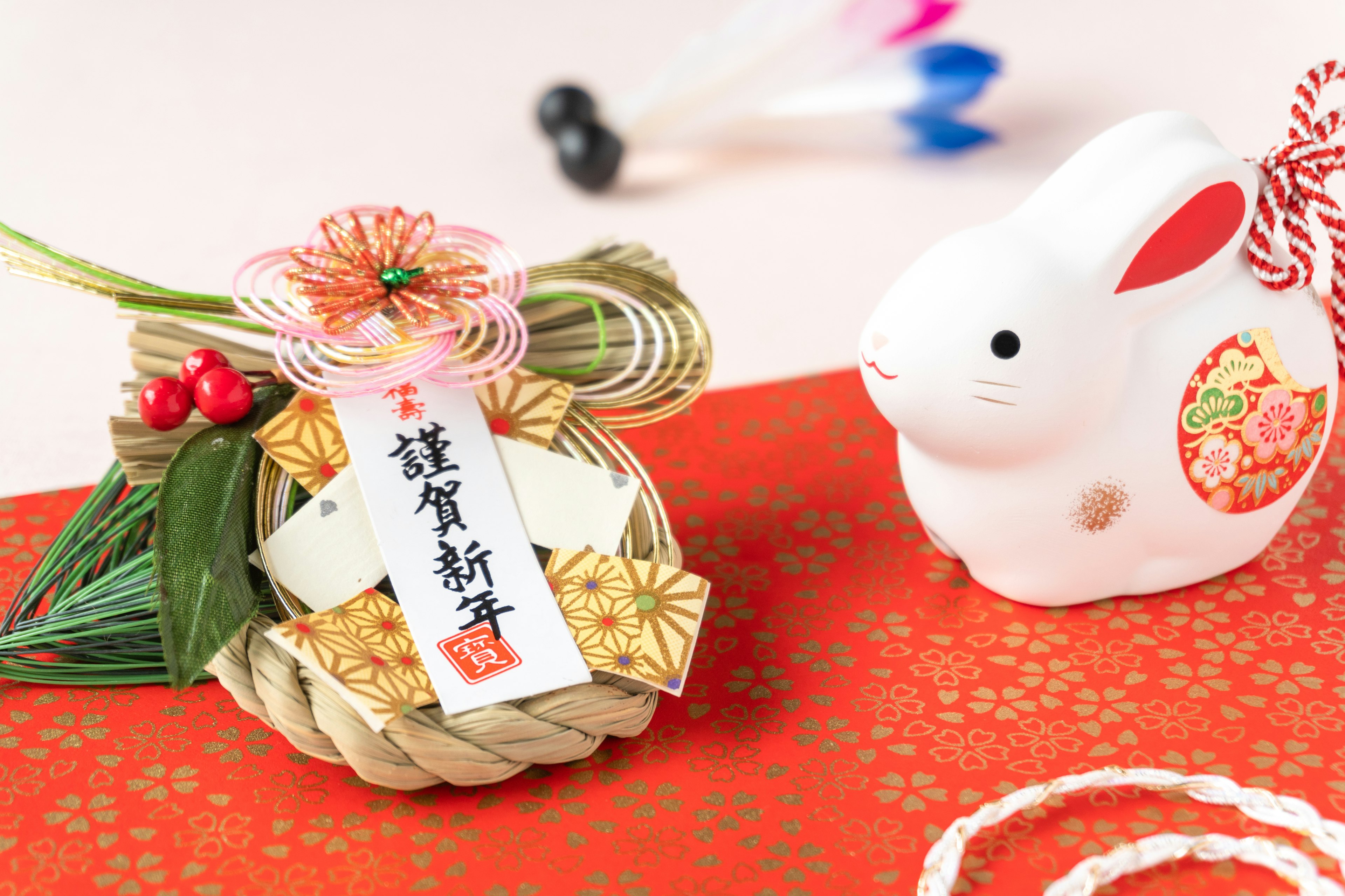 New Year decoration with a white rabbit figurine on a red background