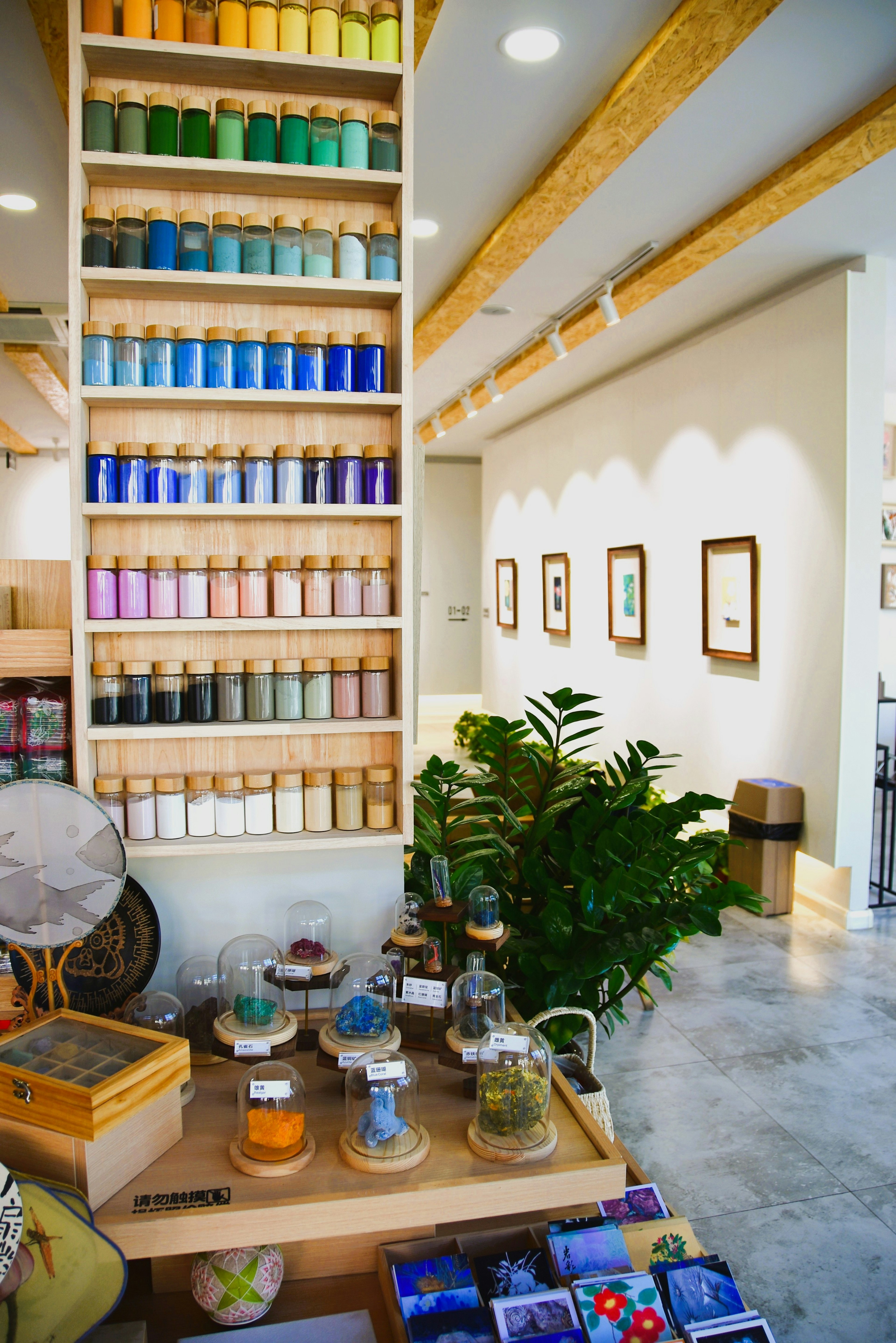 Interior of an art studio featuring colorful jars and a wooden shelf