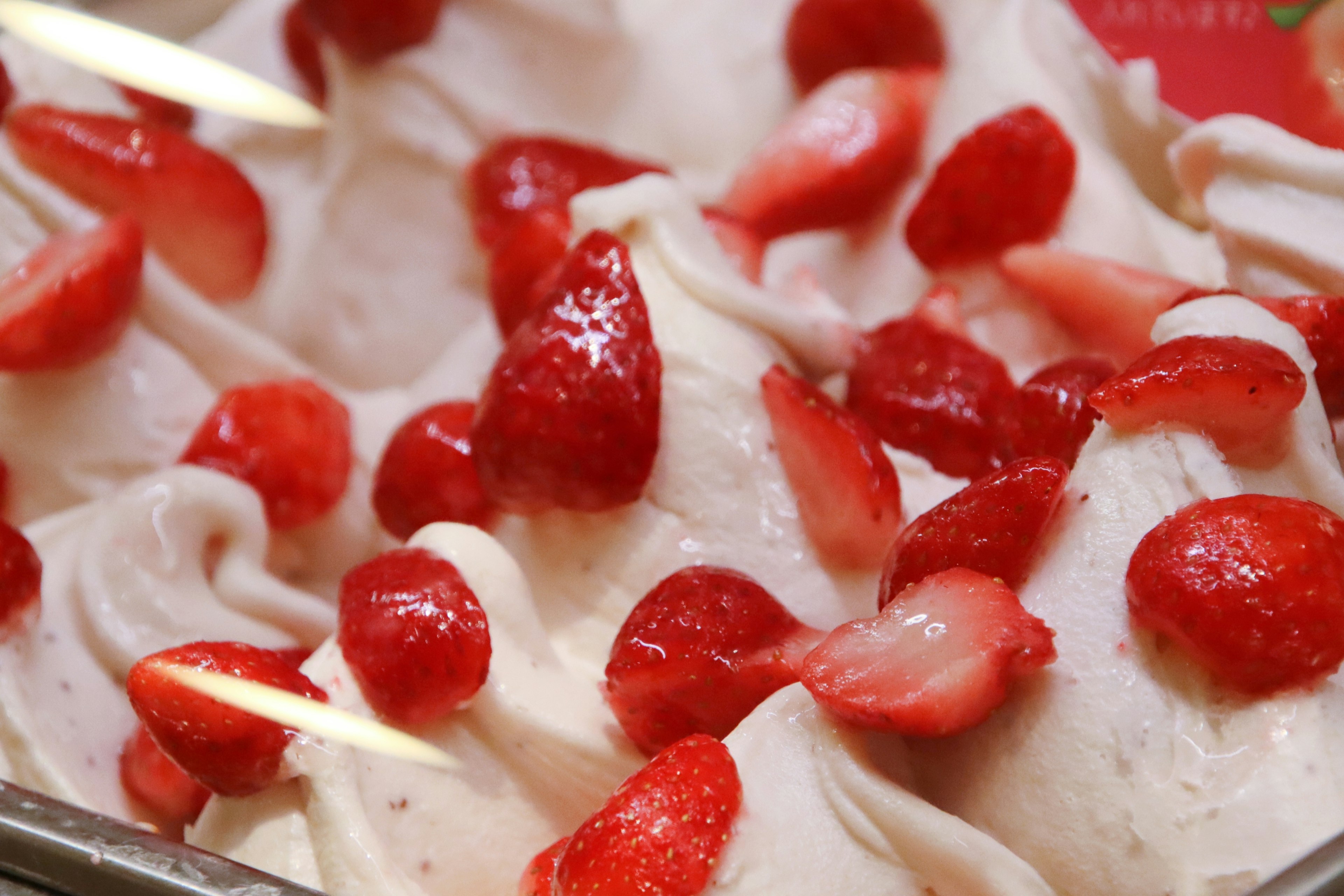 Creamy gelato topped with fresh strawberries