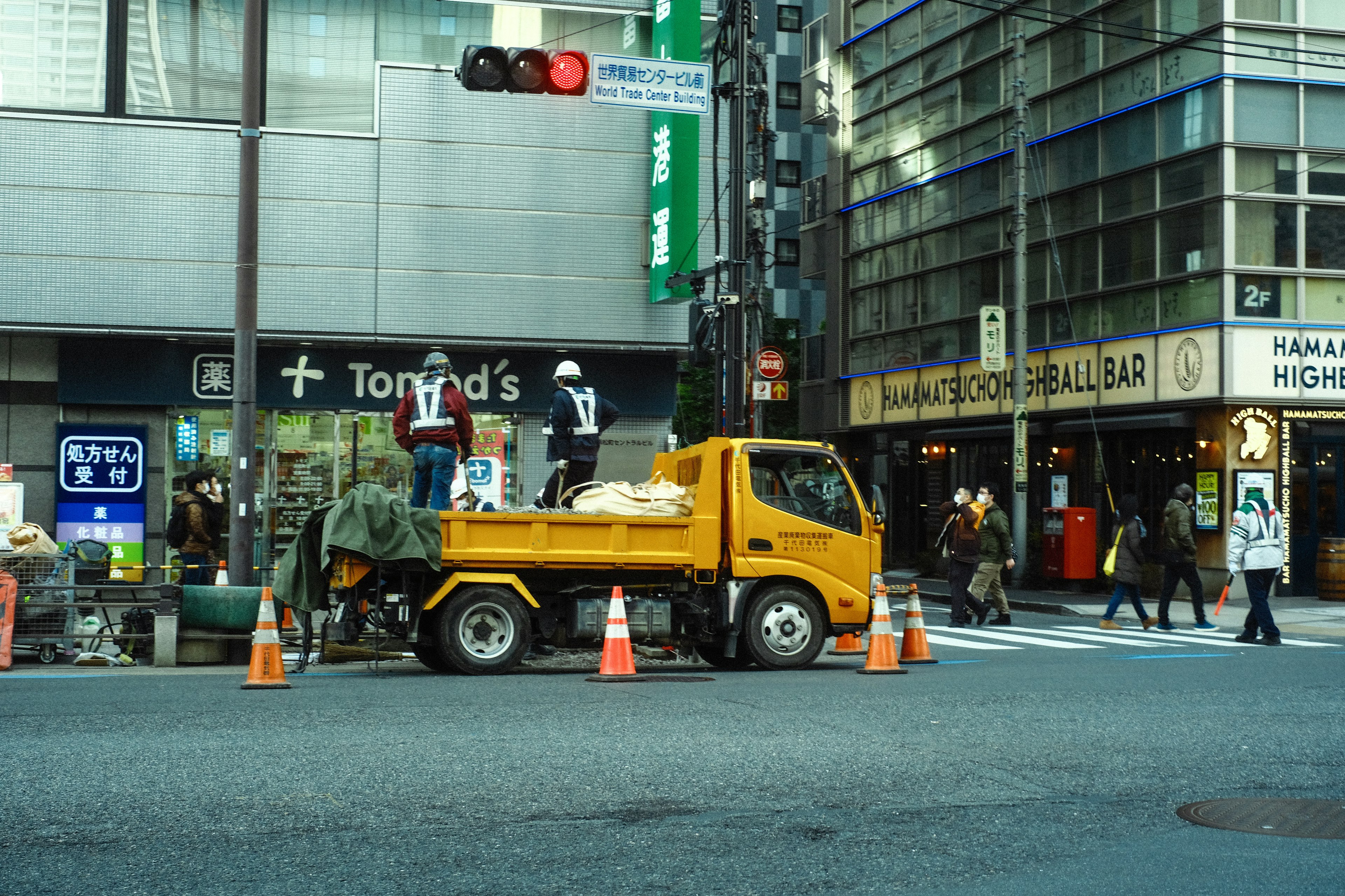 Yellow truck with workers at a street intersection