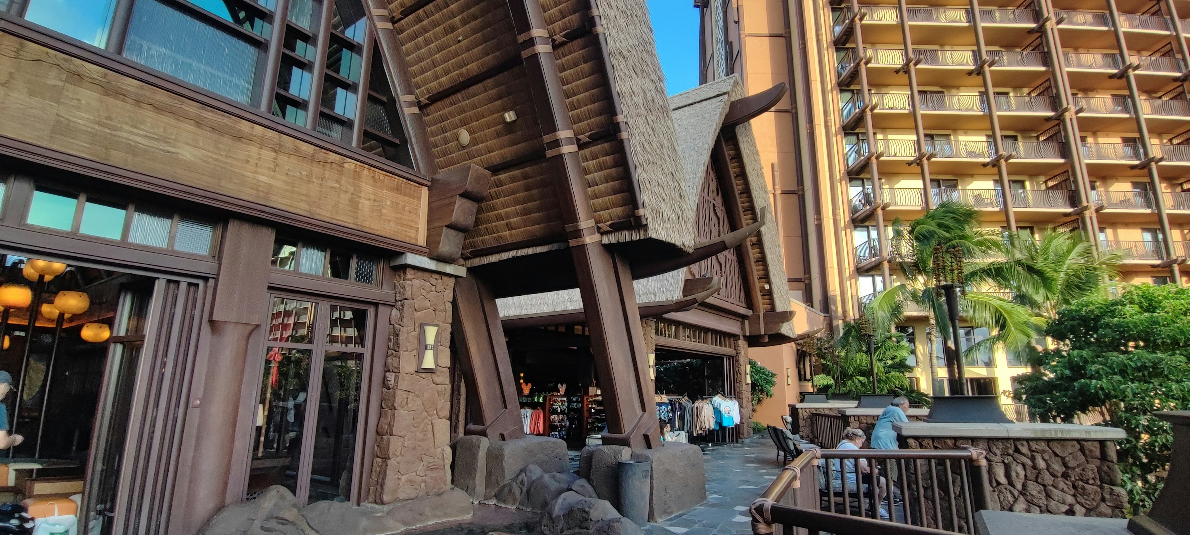 Large wooden building entrance with surrounding greenery