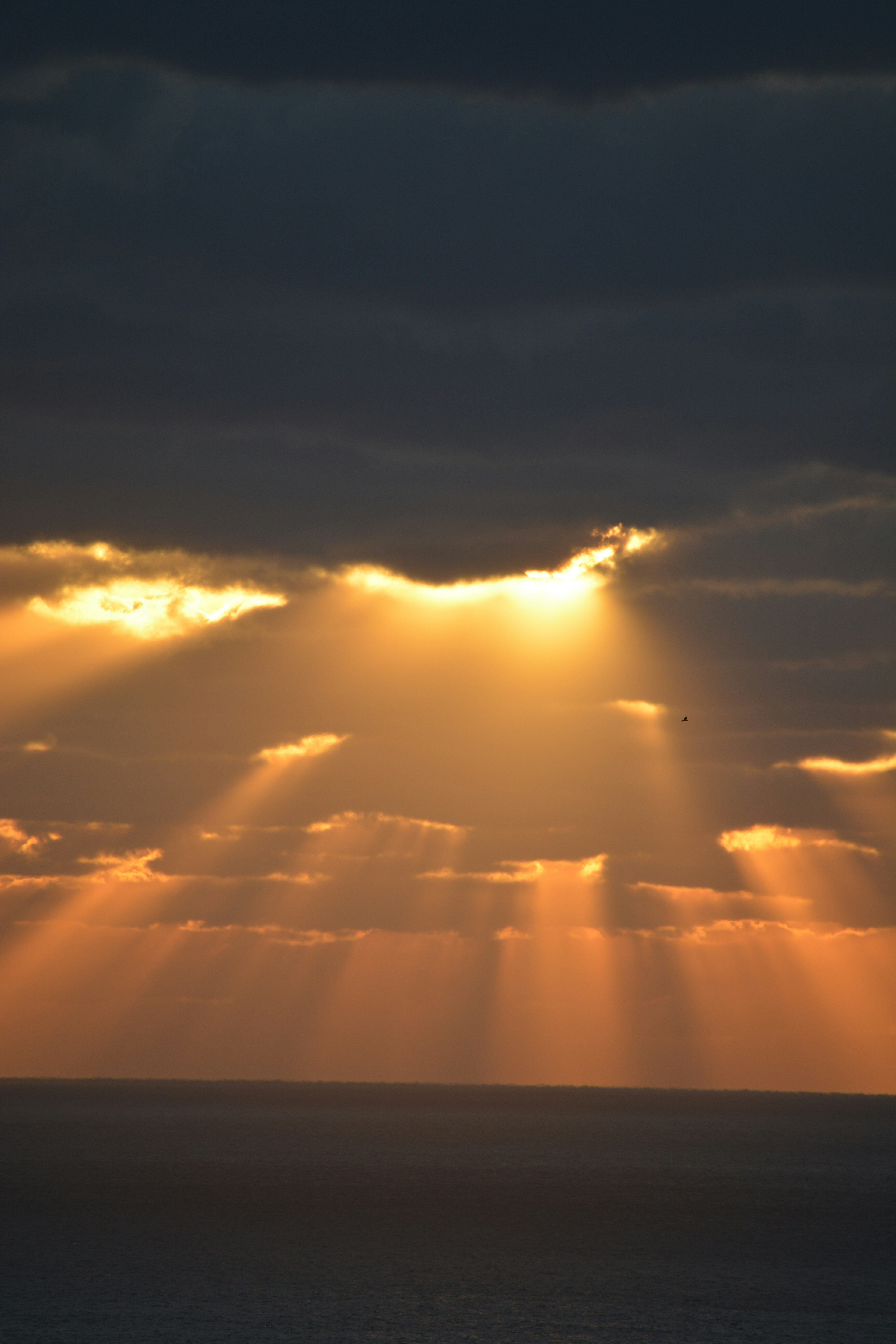 Rayons de soleil passant à travers les nuages au-dessus de l'océan