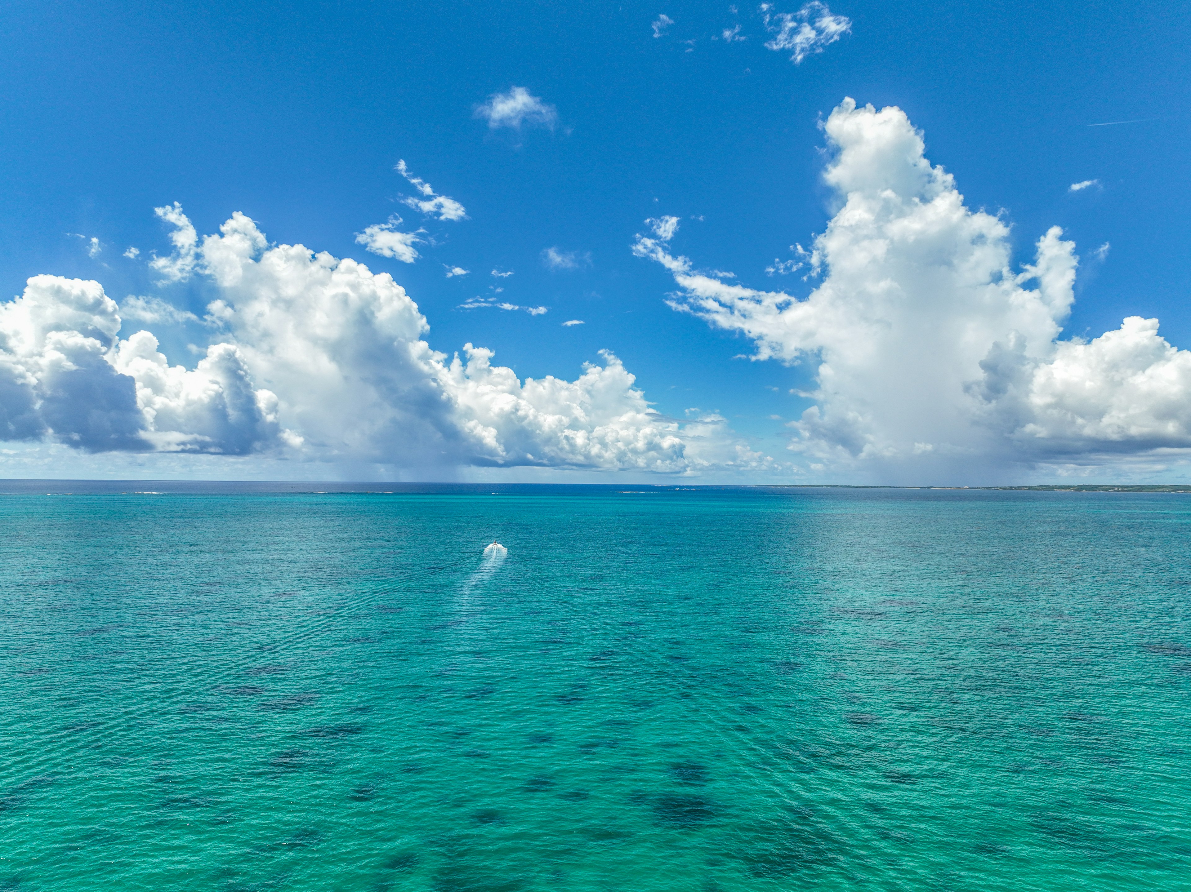 Schöne Szene des blauen Ozeans mit weißen Wolken