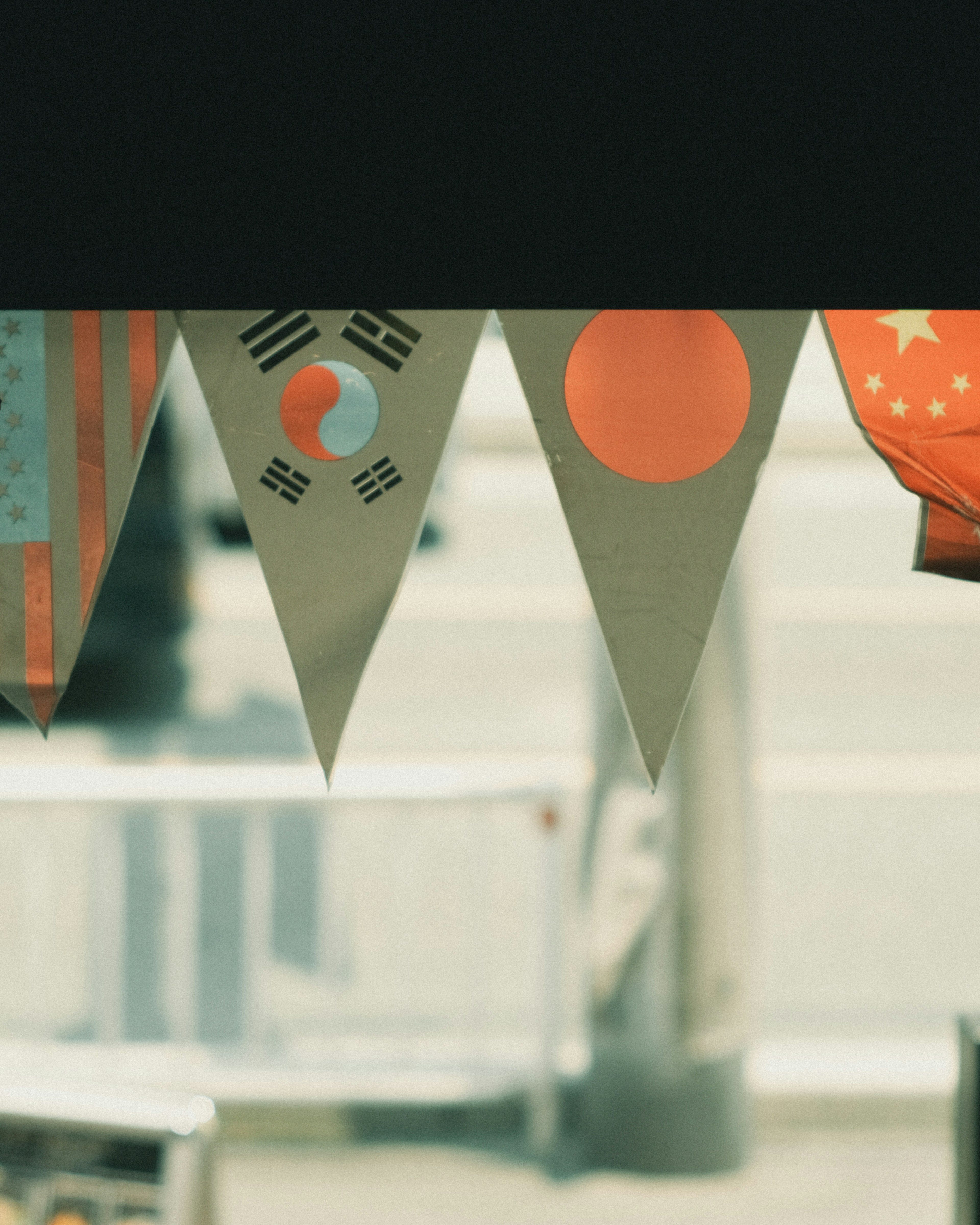 Banners featuring flags of South Korea, Japan, and the United States