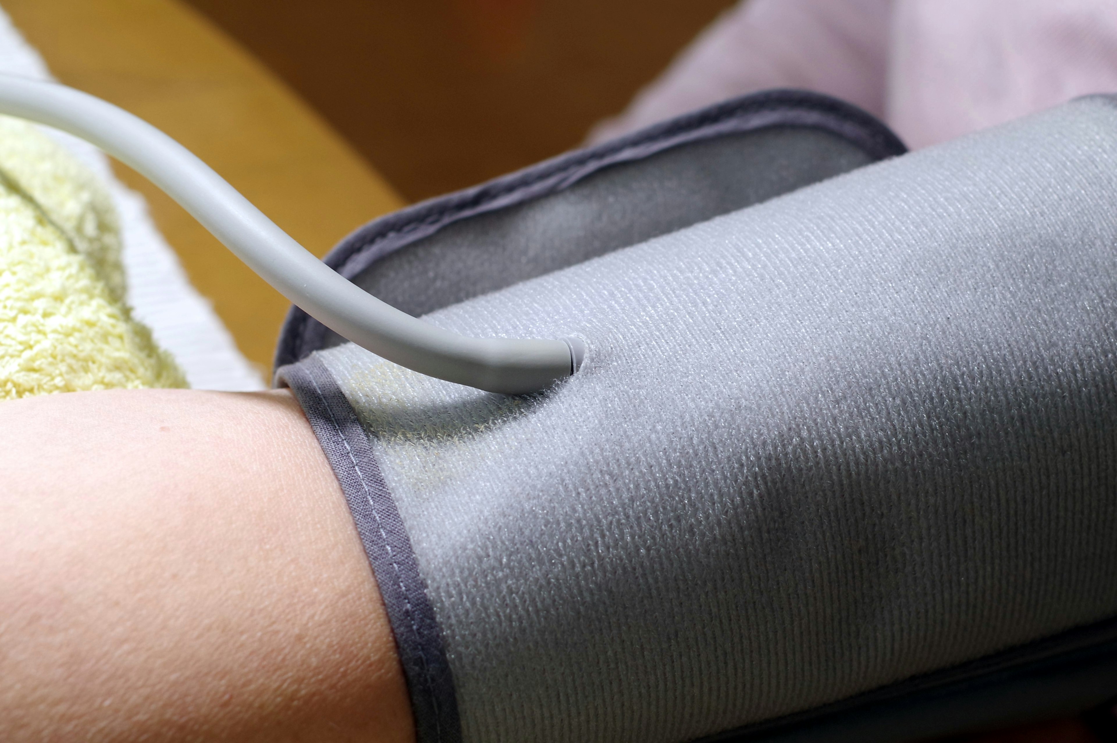 A blood pressure cuff placed on a person's arm