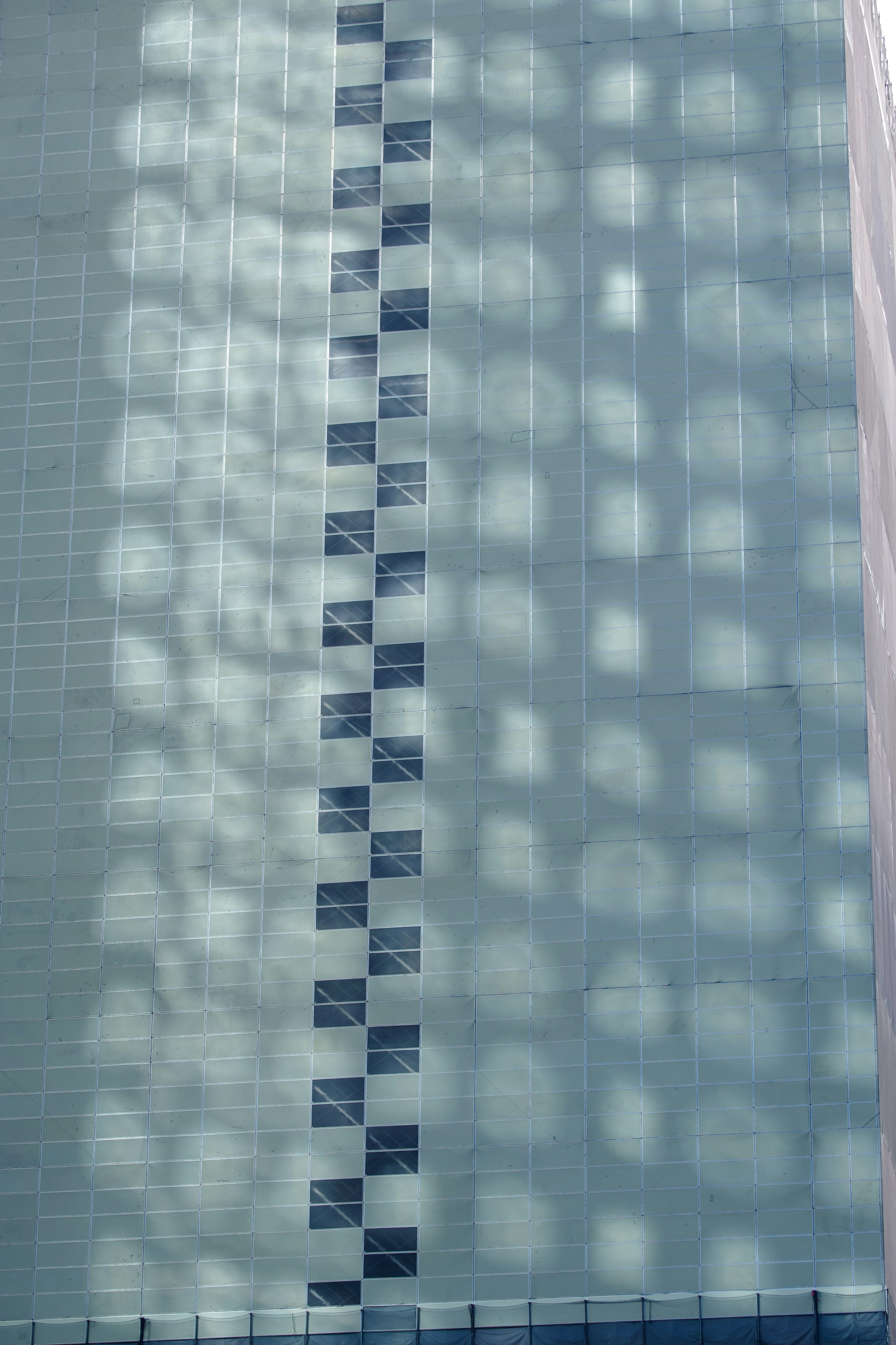 Patterns of light reflecting on a blue building wall