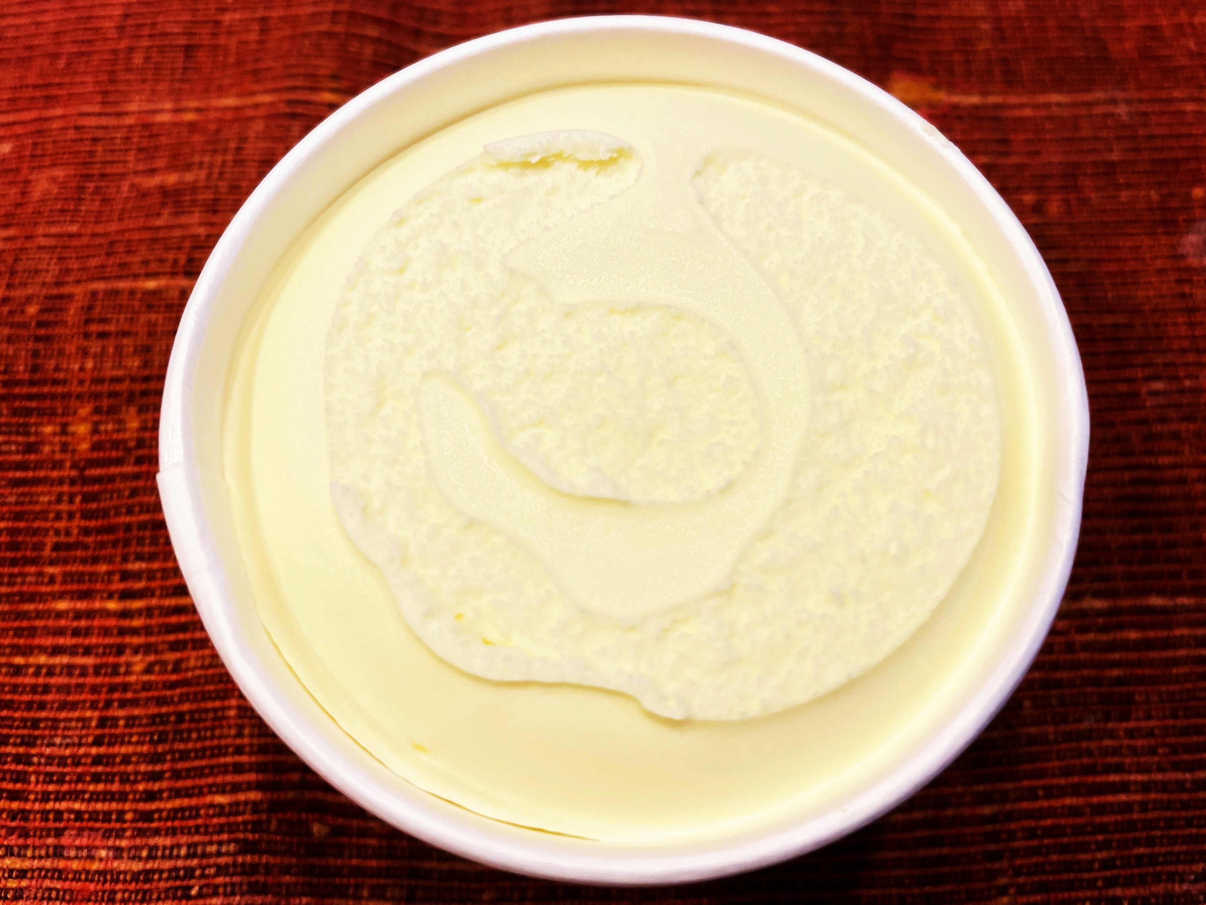 Creamy white dip in a white bowl on a wooden surface