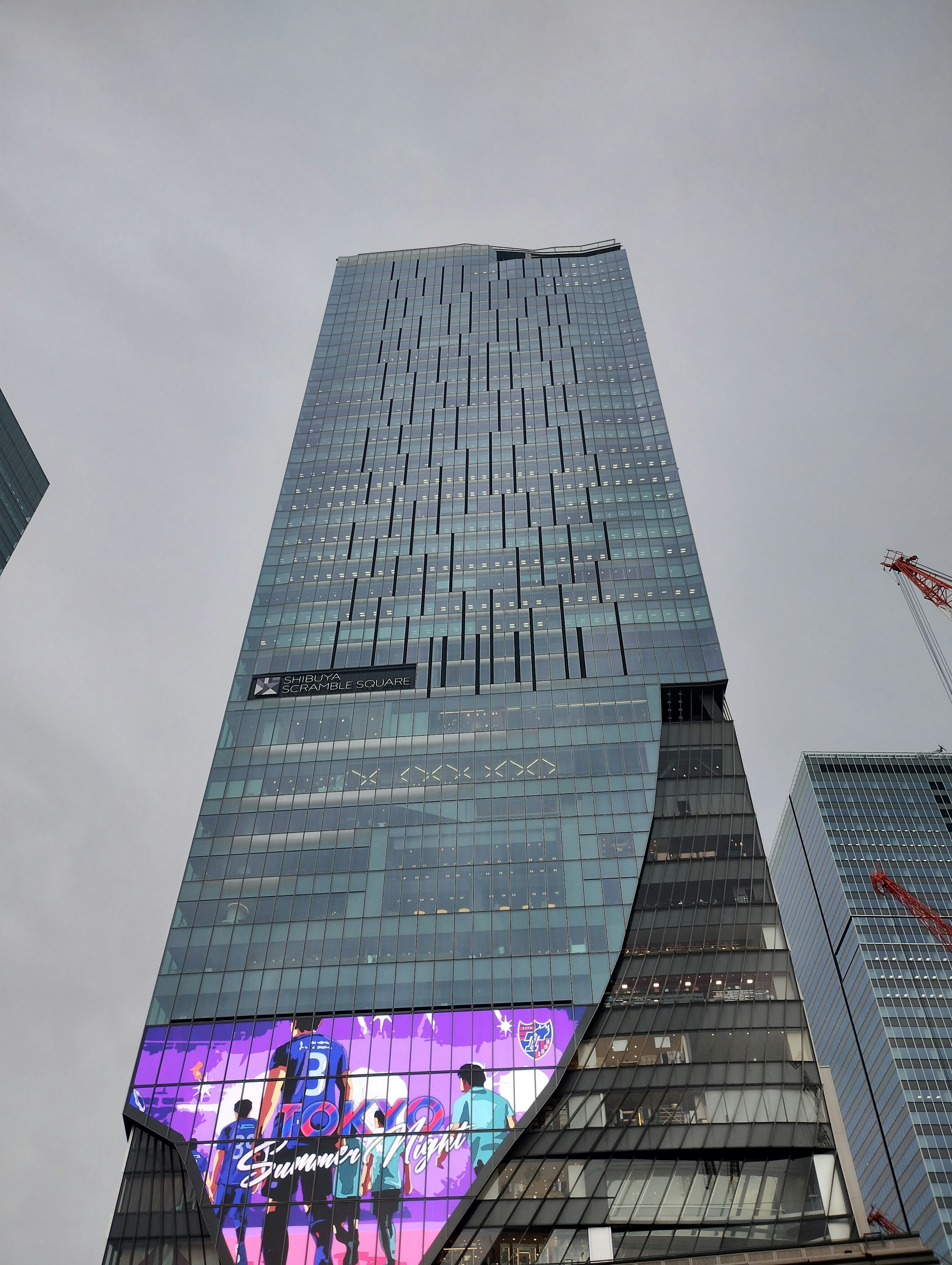 Skyscraper with a large advertising panel featuring vibrant colors