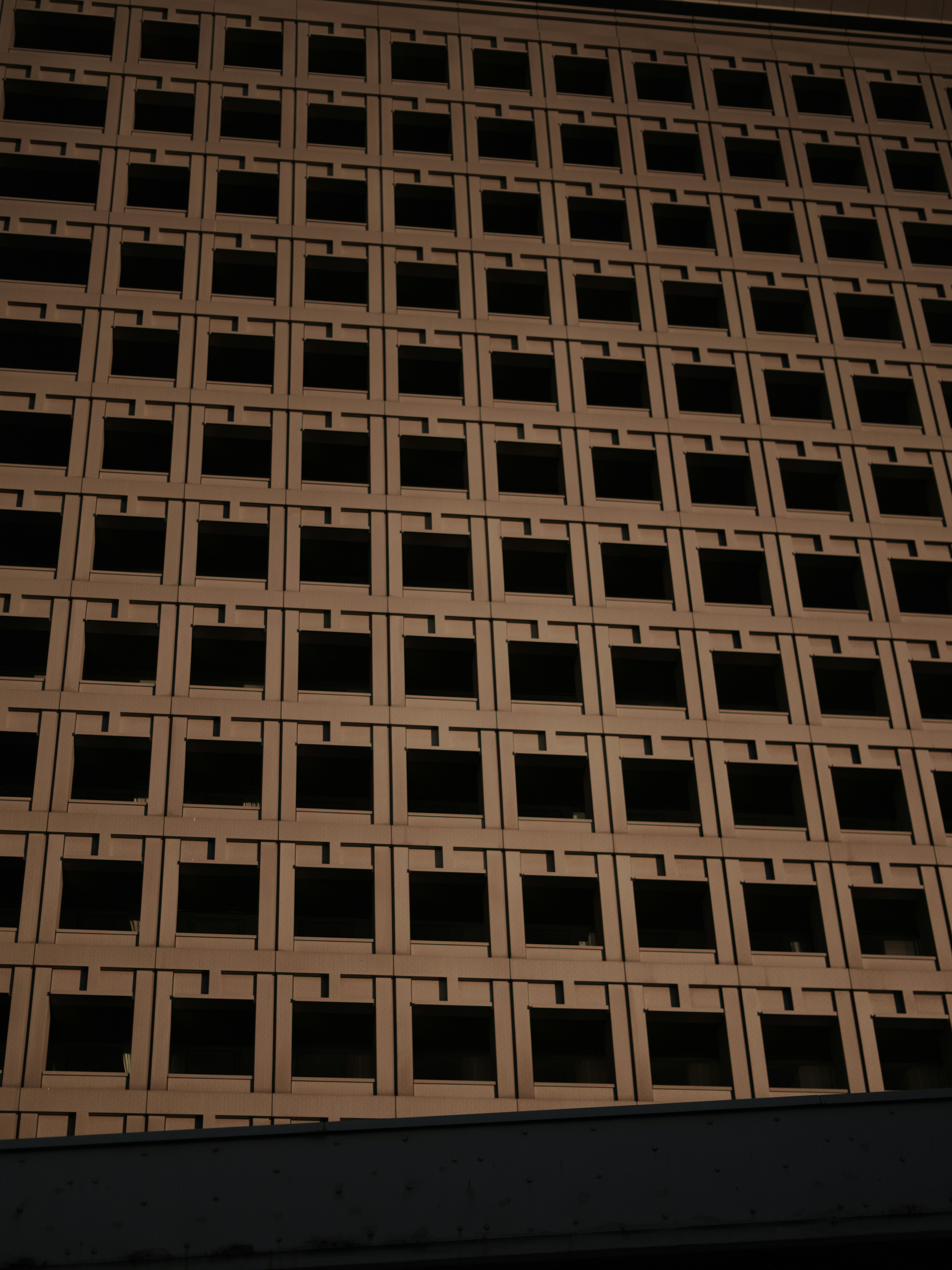 Facade of a building featuring a grid of square windows