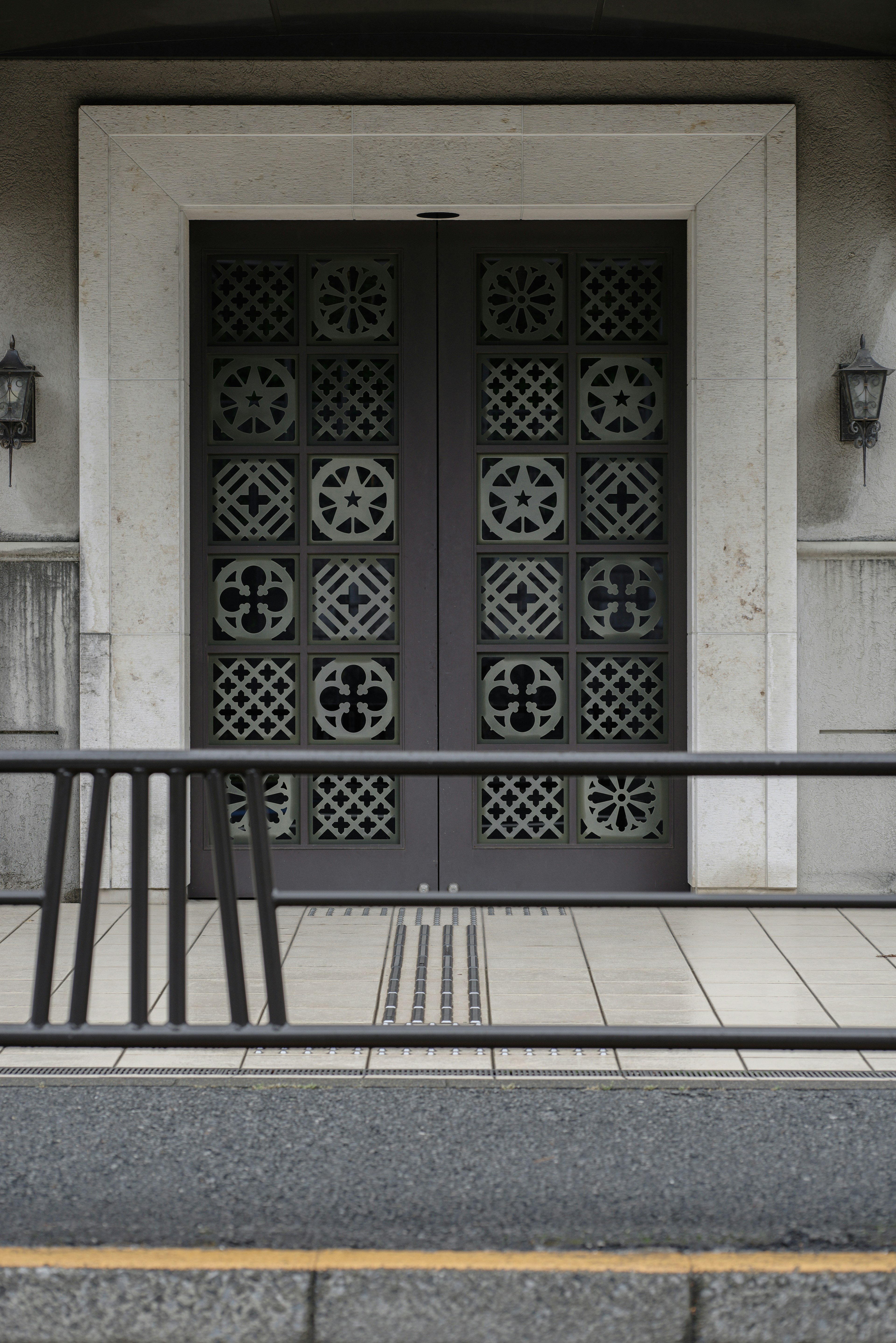 Decorative door with intricate design and modern building facade