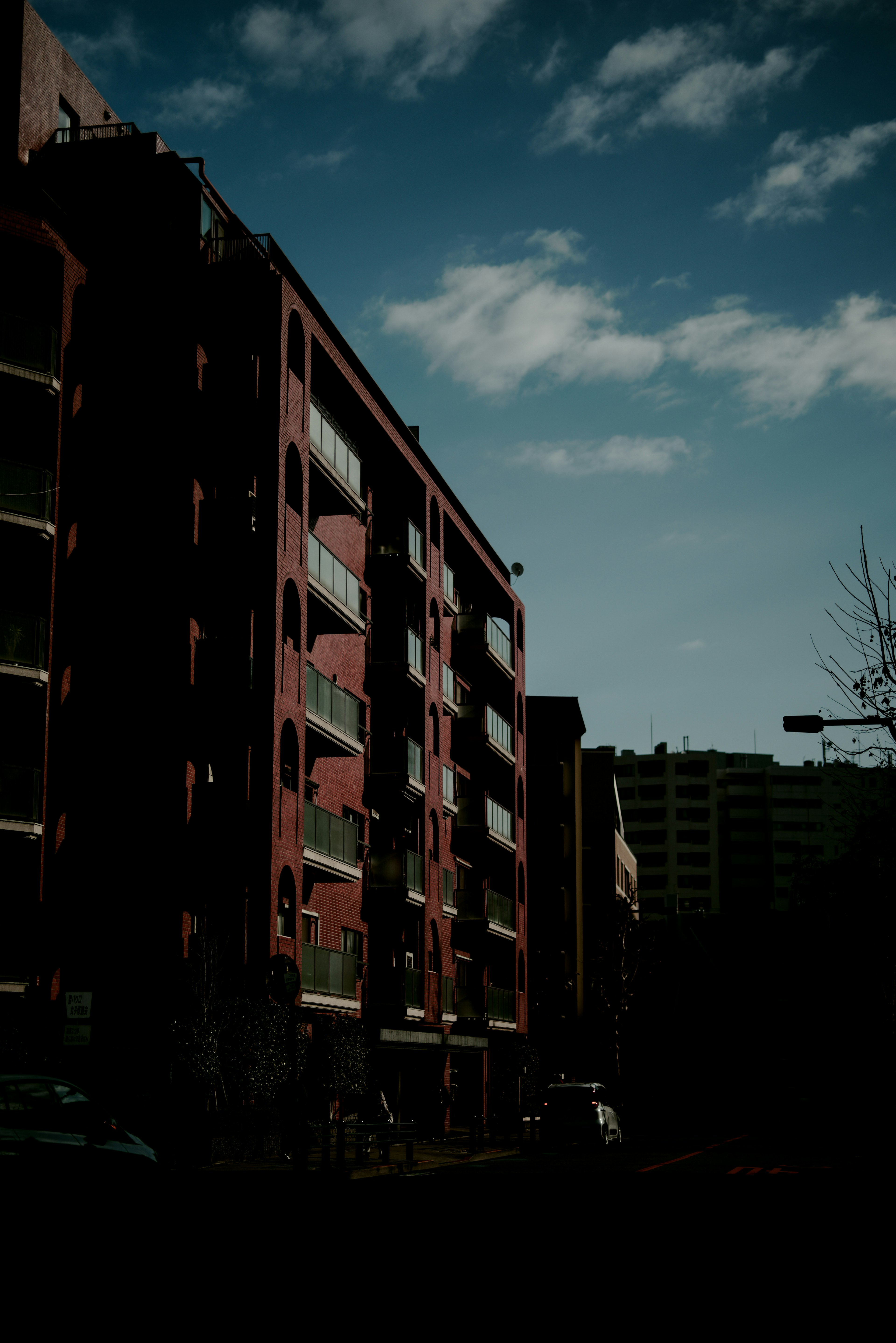 Urban landscape featuring red buildings against a blue sky