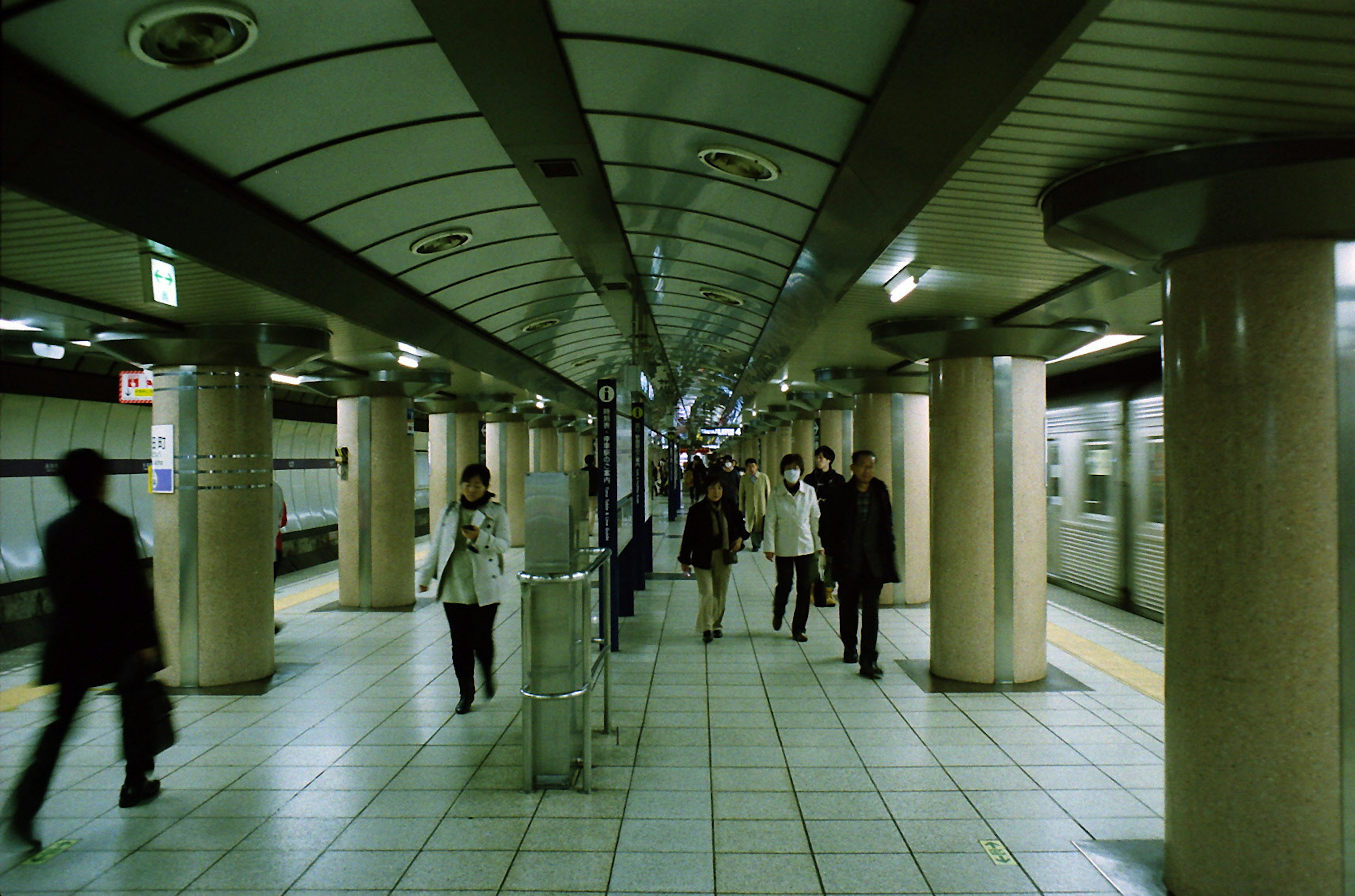 People walking in a subway station corridor