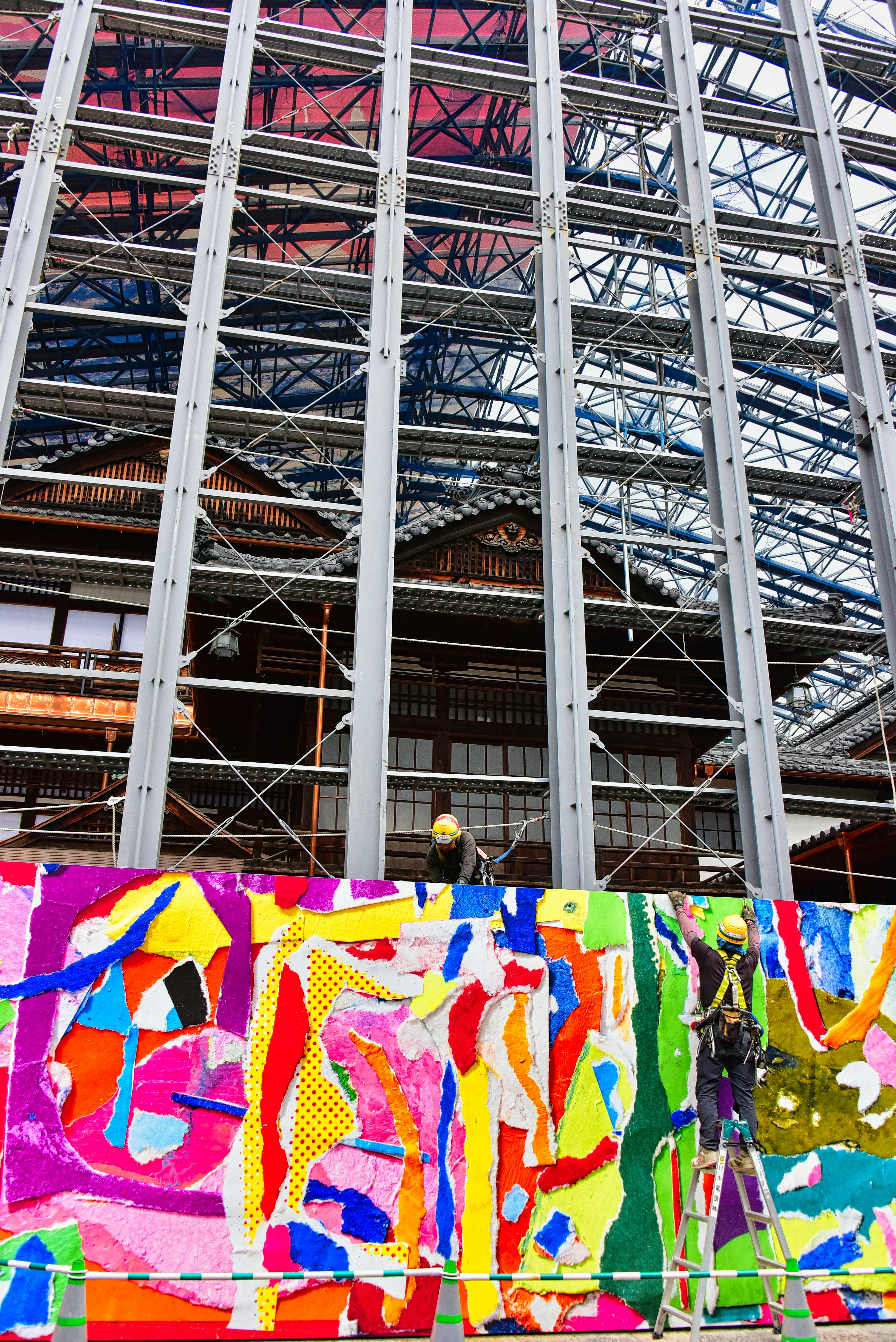 Colorful artwork on a construction site with a steel frame