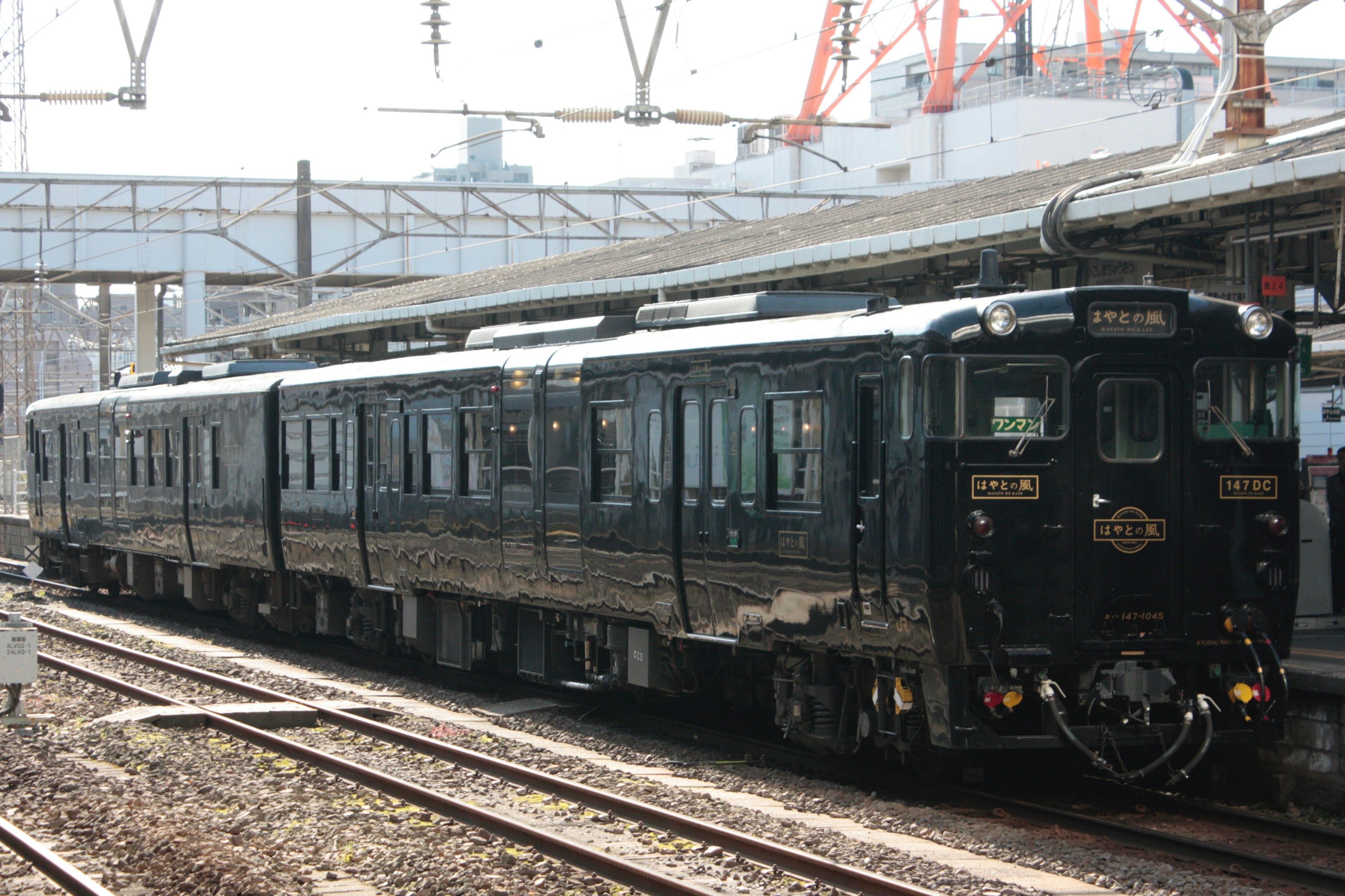 A black vintage train parked at a station