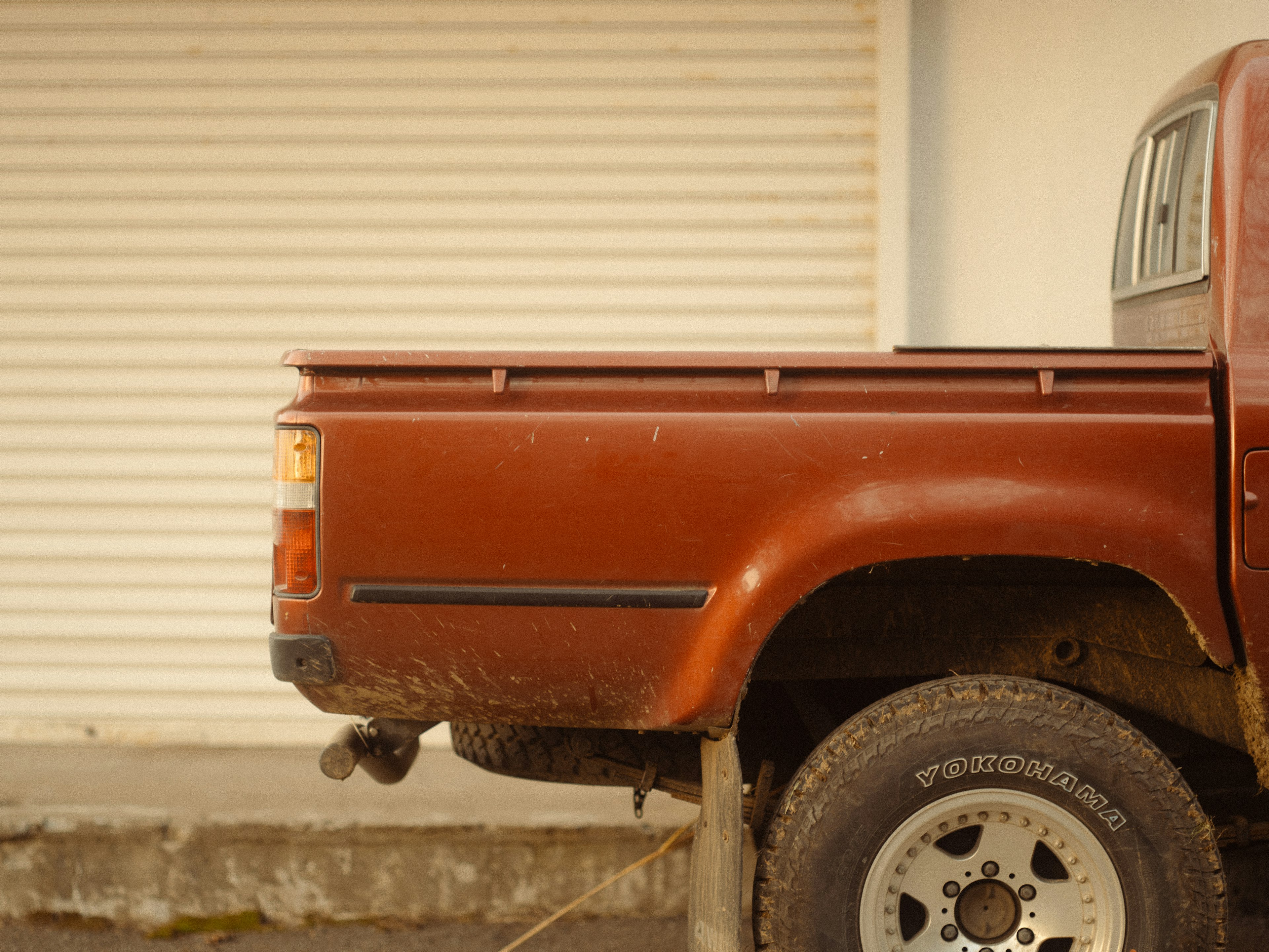 Side view of a brown truck bed with a textured surface