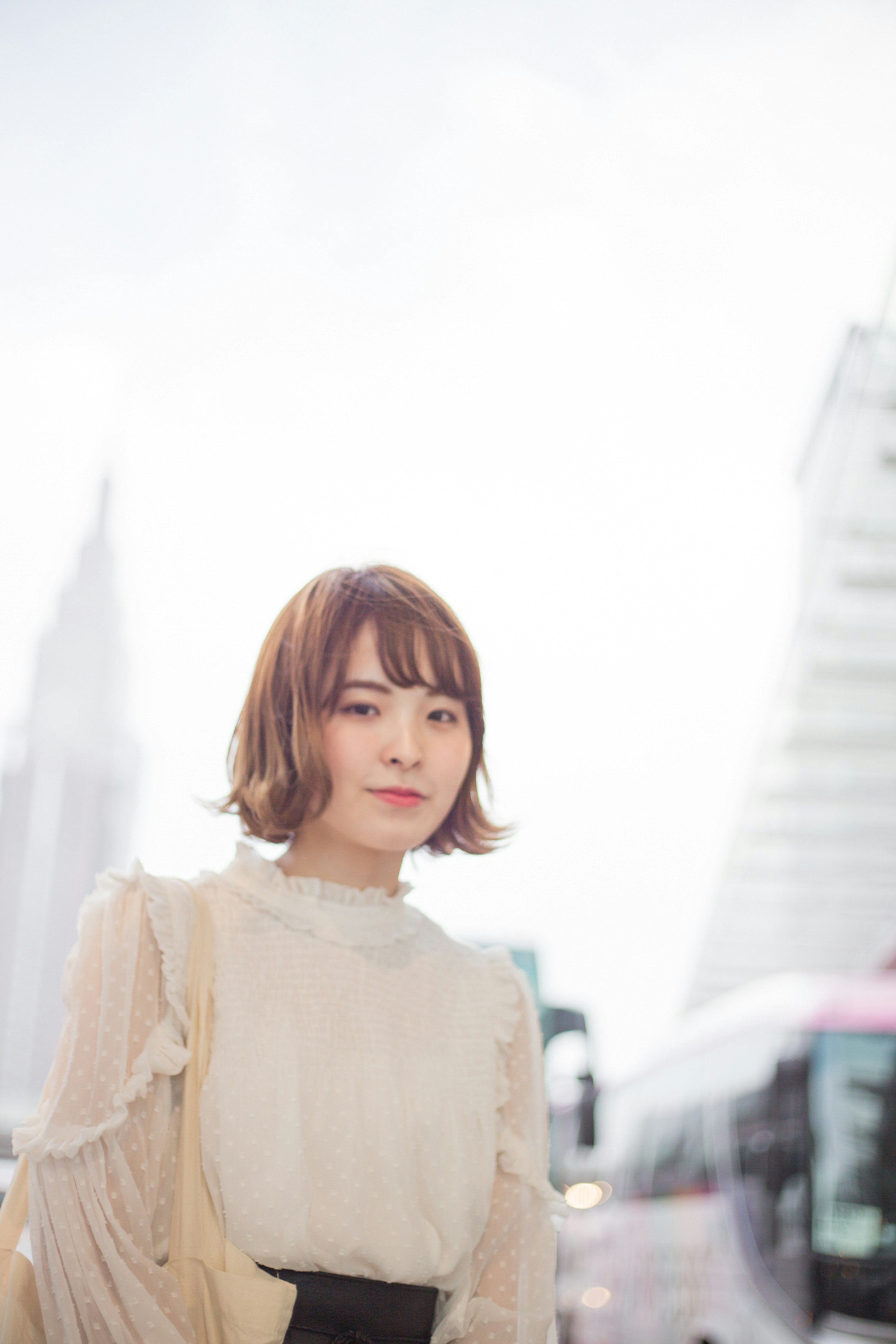 A woman smiling against a bright background