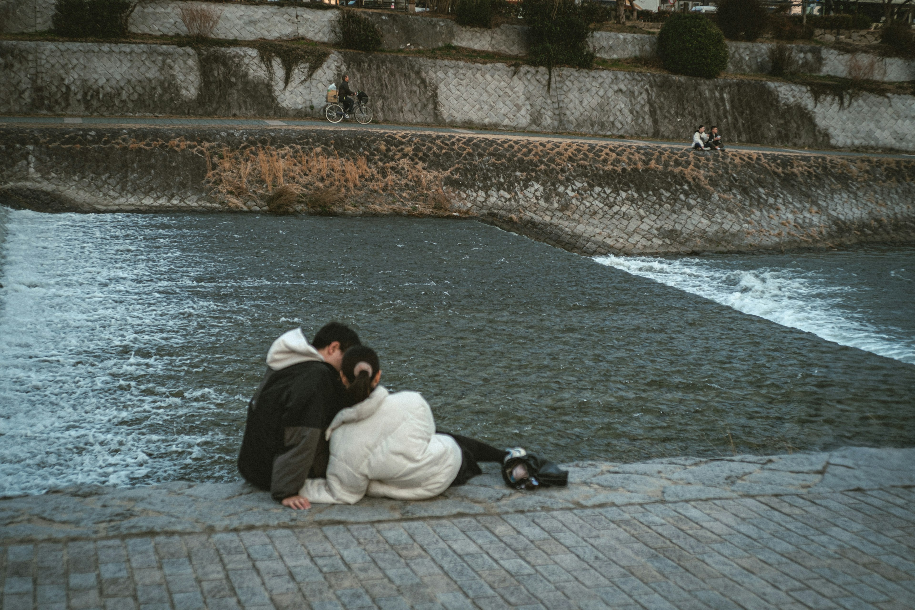 Couple embracing by the riverside