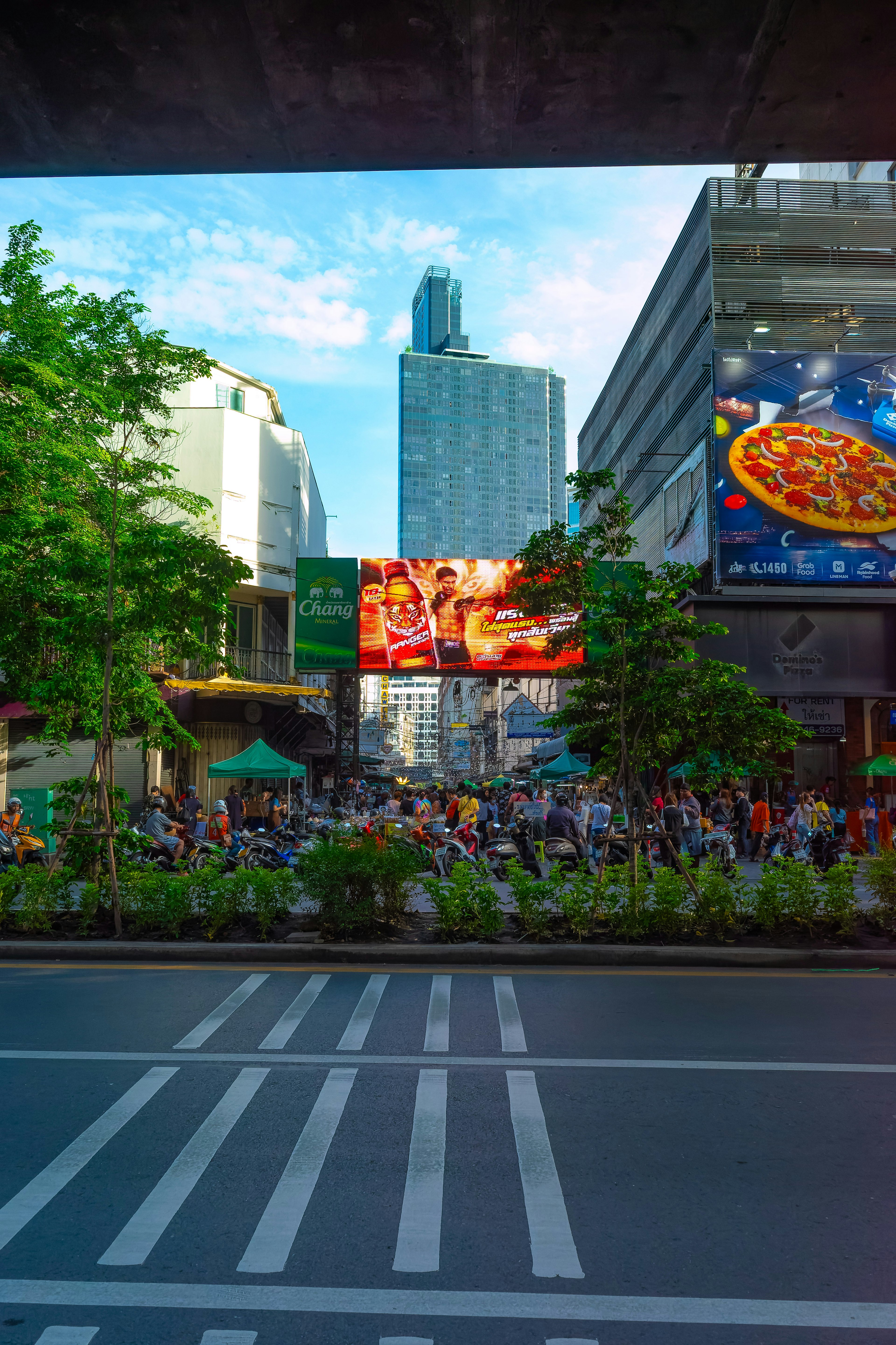 Urban scene featuring a bustling square with people and skyscrapers in the background