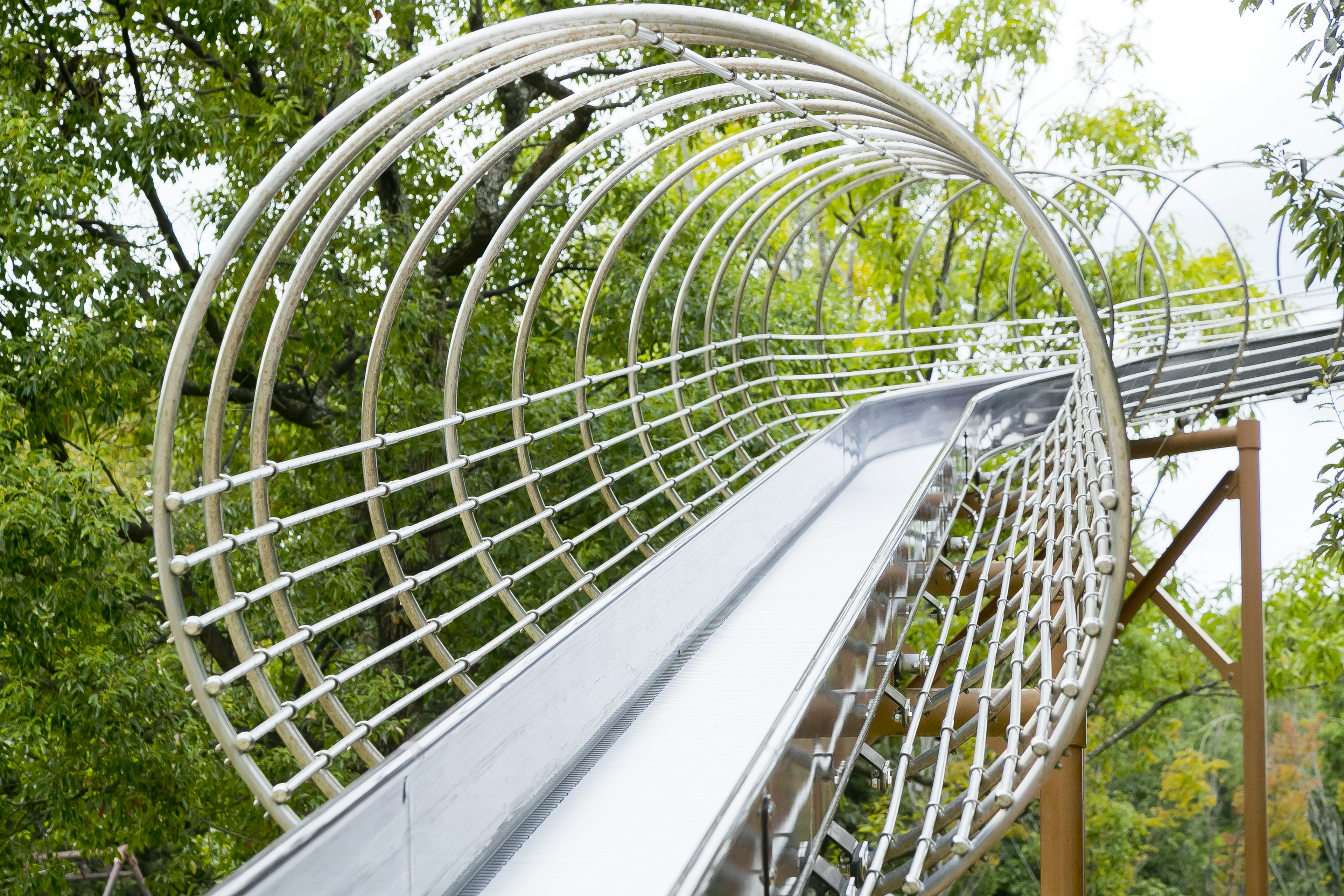 White slide surrounded by a circular frame in a playground