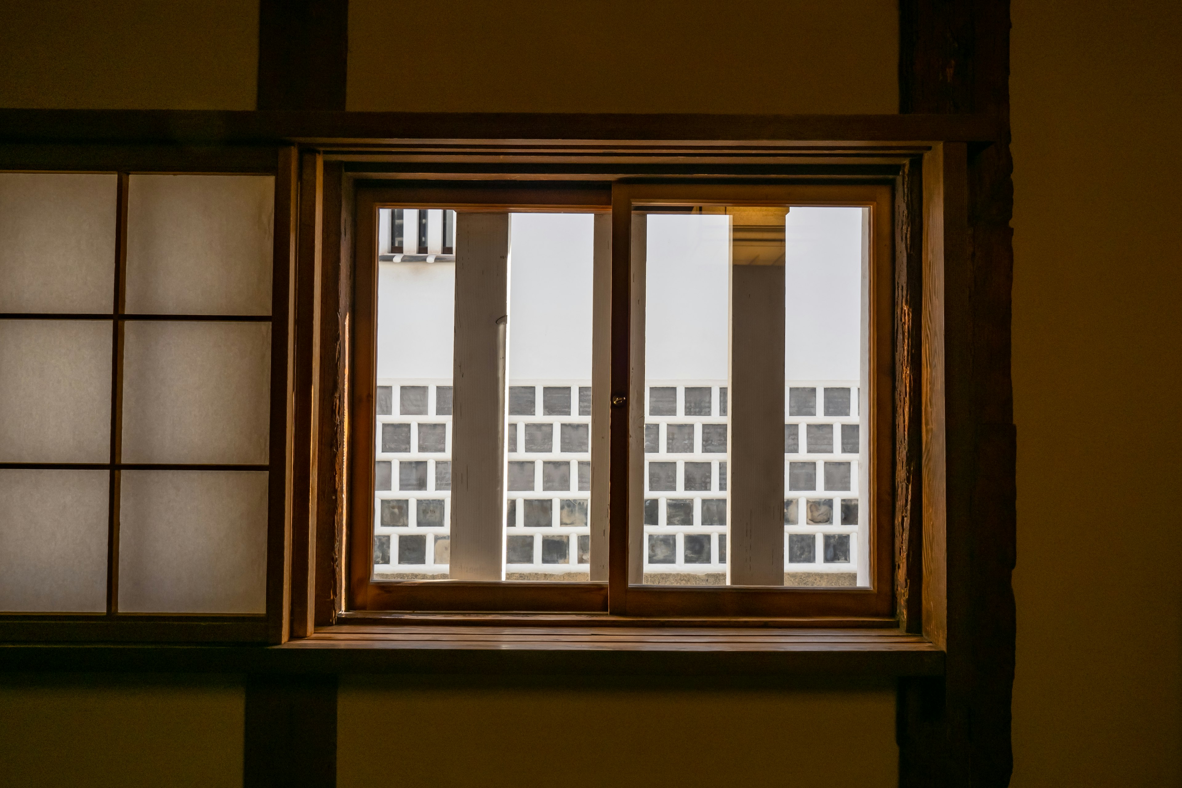 Wooden window frame revealing a modern building exterior