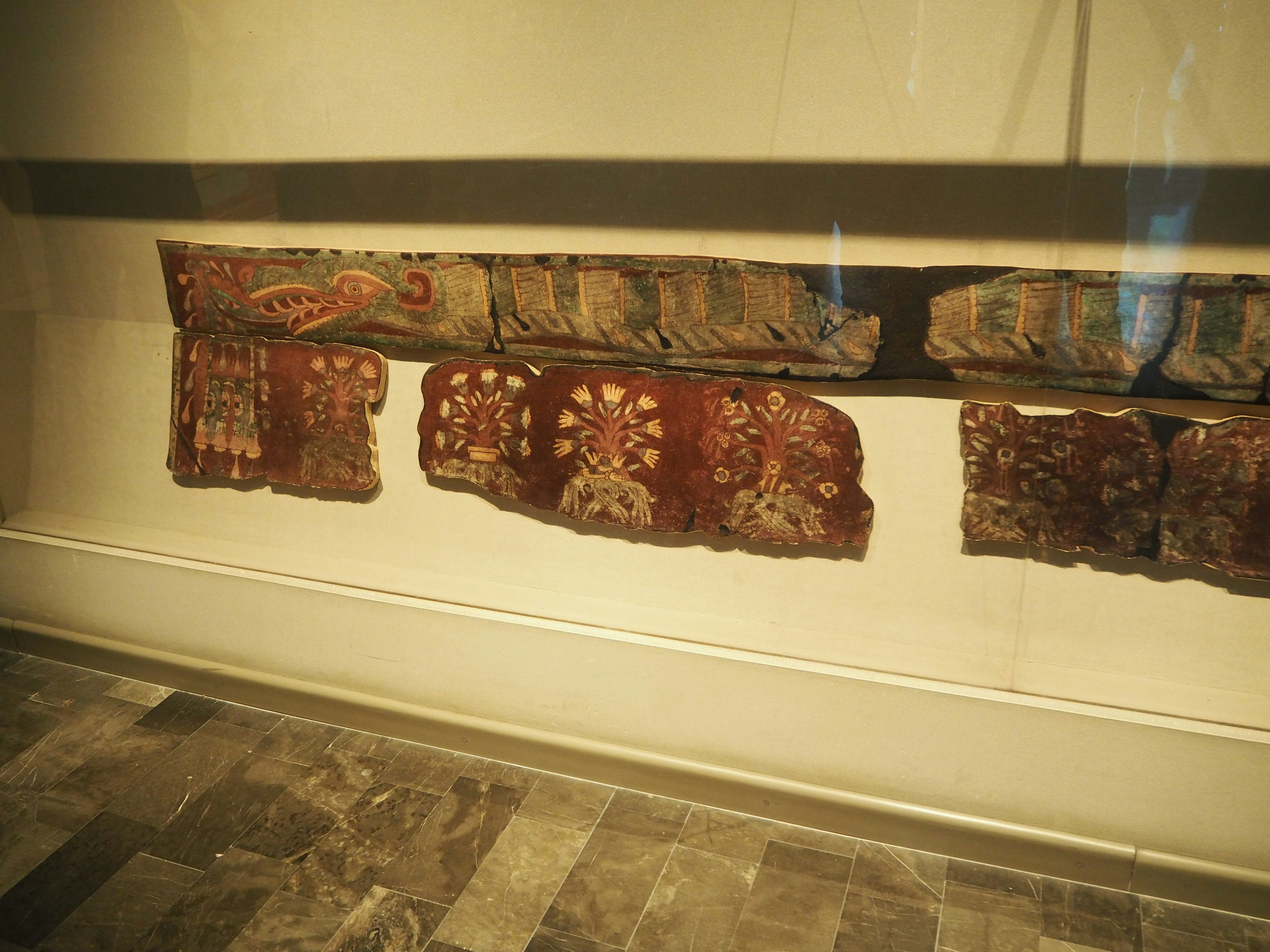 Fragments of ancient textiles displayed in a museum interior