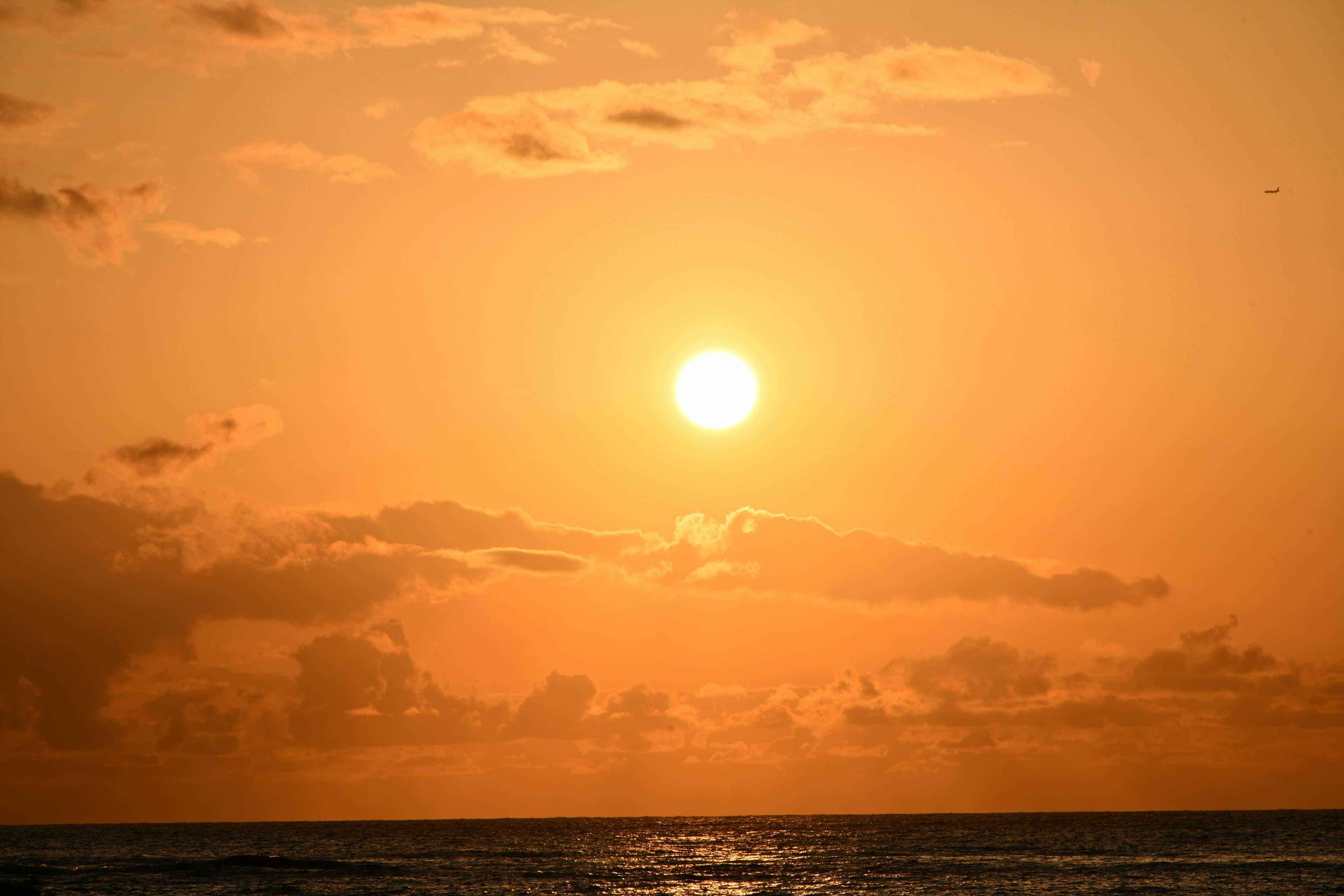 Hermoso cielo naranja con el sol poniéndose sobre el océano