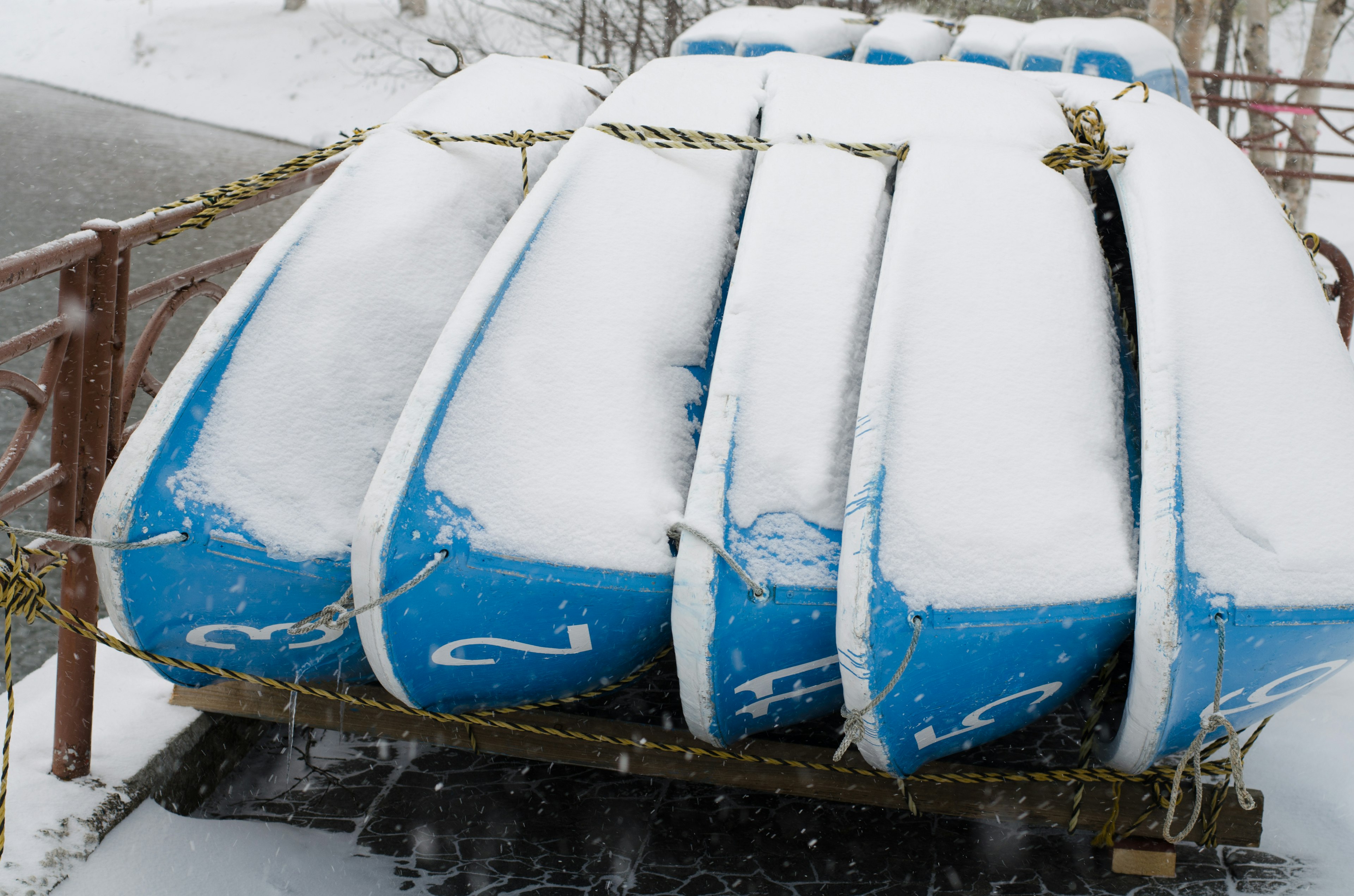 Canoas azules apiladas cubiertas de nieve