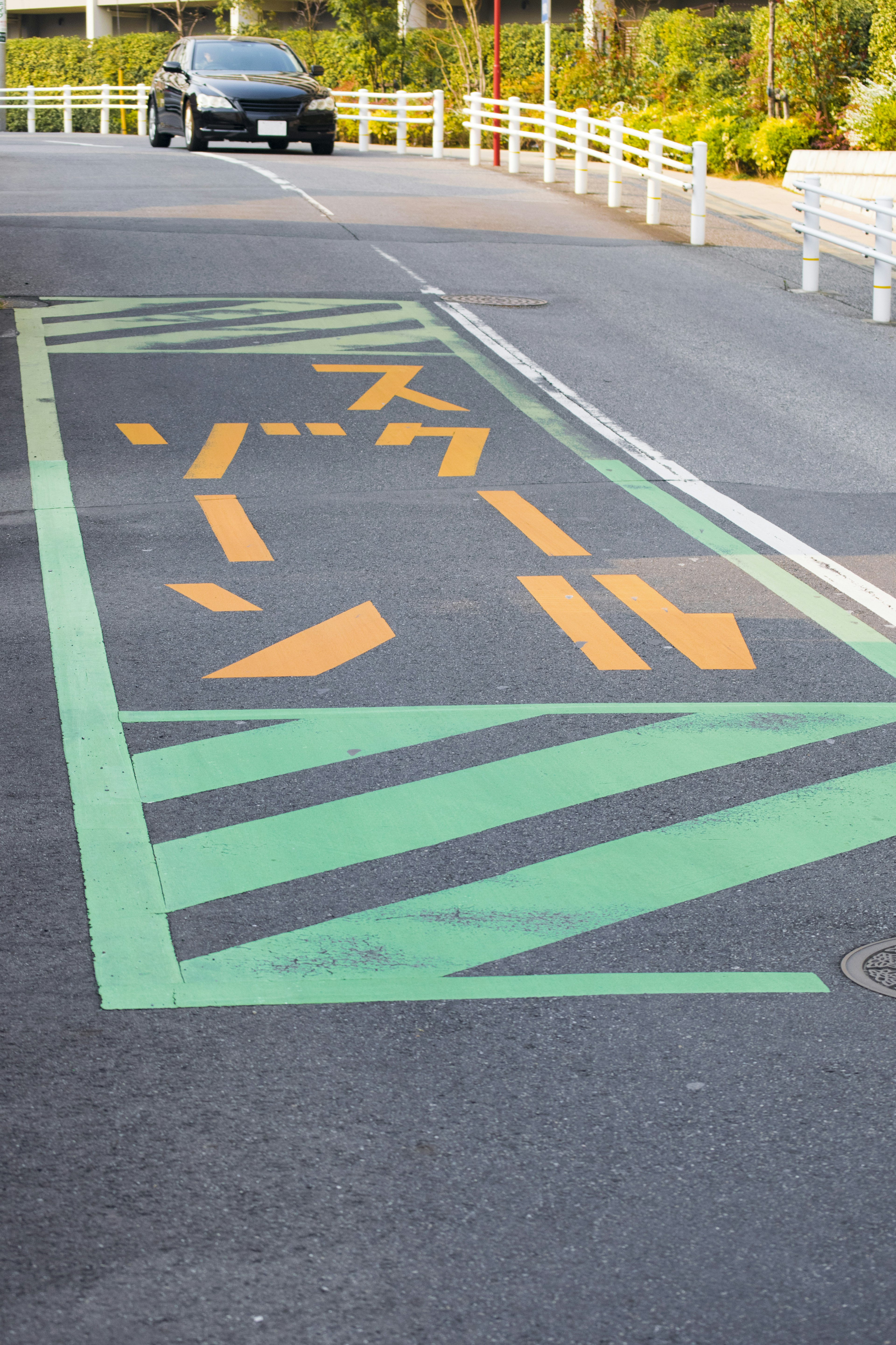 Scène de route avec des marquages orange et des lignes vertes sur le pavé